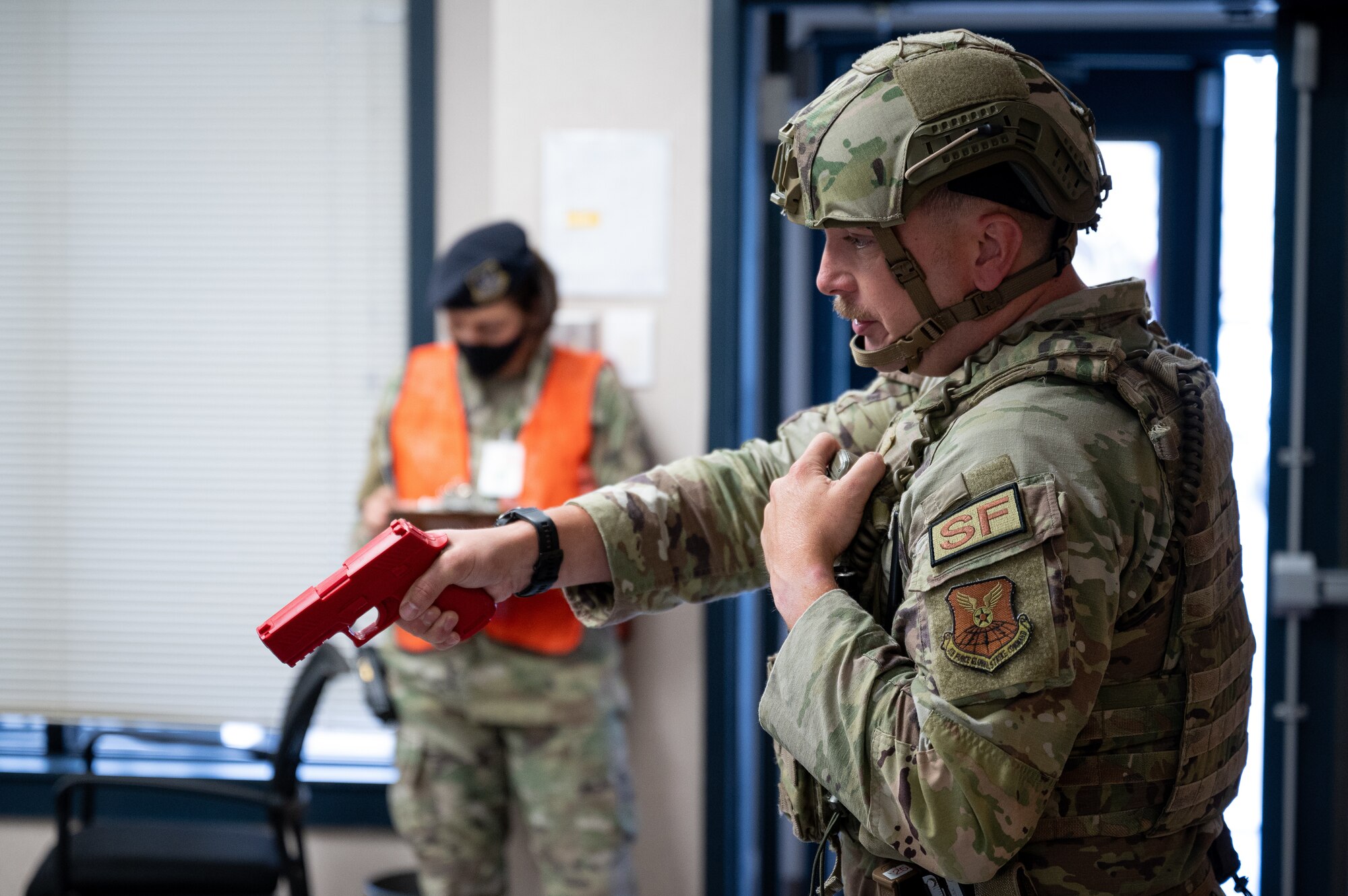 Tech. Sgt. Jacob Udell, 2nd Security Forces Squadron flight sergeant, draws a weapon on a hostile during an active shooter exercise at Barksdale Air Force Base, Louisiana, Sept. 16, 2021. The exercise was designed to evaluate the training, readiness and capability of Barksdale’s first responders in order to effectively respond to active shooter threats to the installation. (U.S. Air Force photo by Airman 1st Class Jonathan E. Ramos)