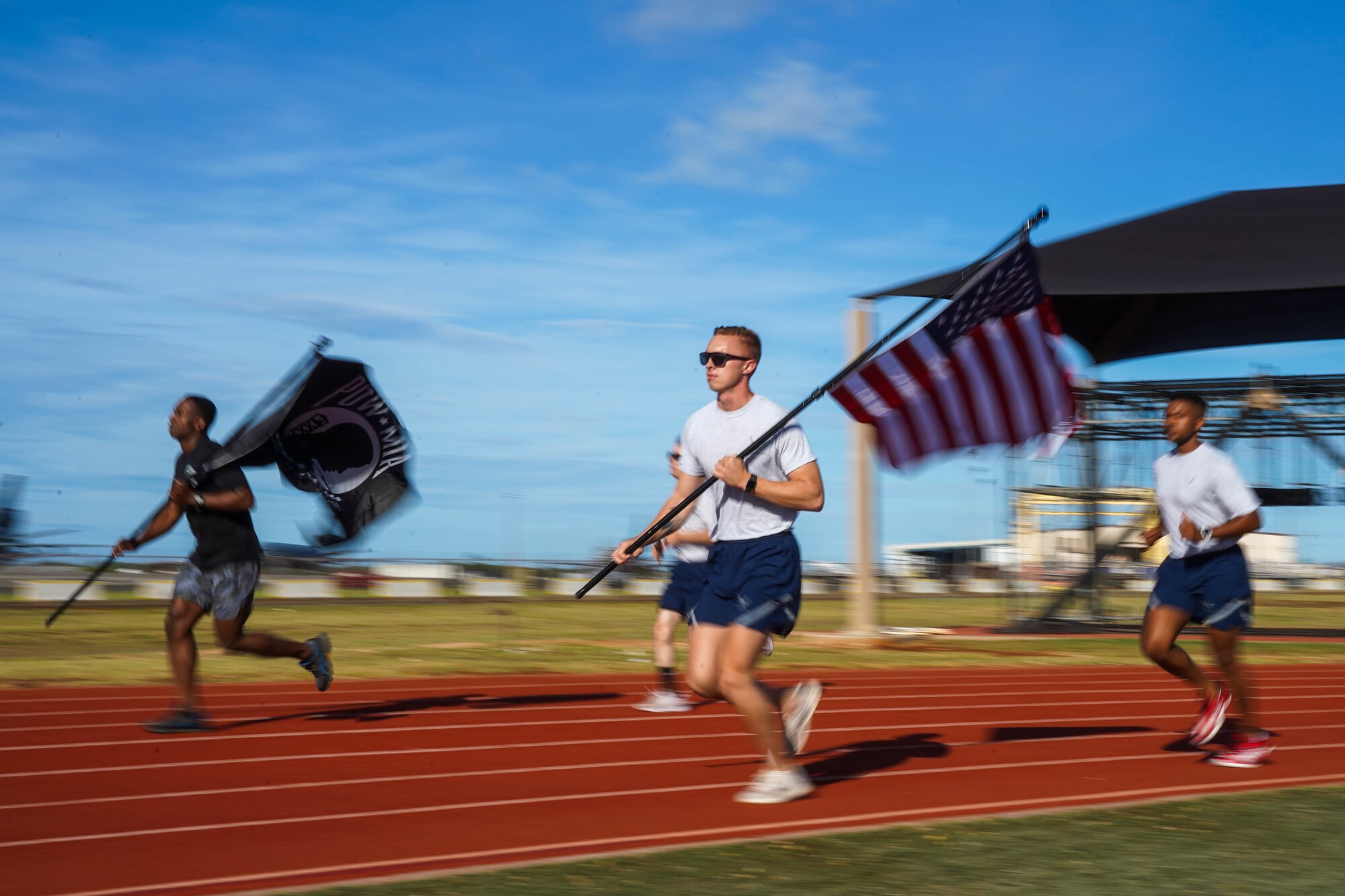 Airmen from 674th Airbase Group participate in a 24-hour run in honor of Prisoners of War and Missing in Action Remembrance Week at Joint Base Pearl Harbor-Hickam, Hawaii, Sept. 16, 2021. During the run, the POW/MIA flag will stay in motion for 24 hours by volunteers running with the flag to commemorate and symbolize the unwavering pursuit to recover all service members past and present. (U.S. Air Force photo by Airman 1st Class Makensie Cooper)