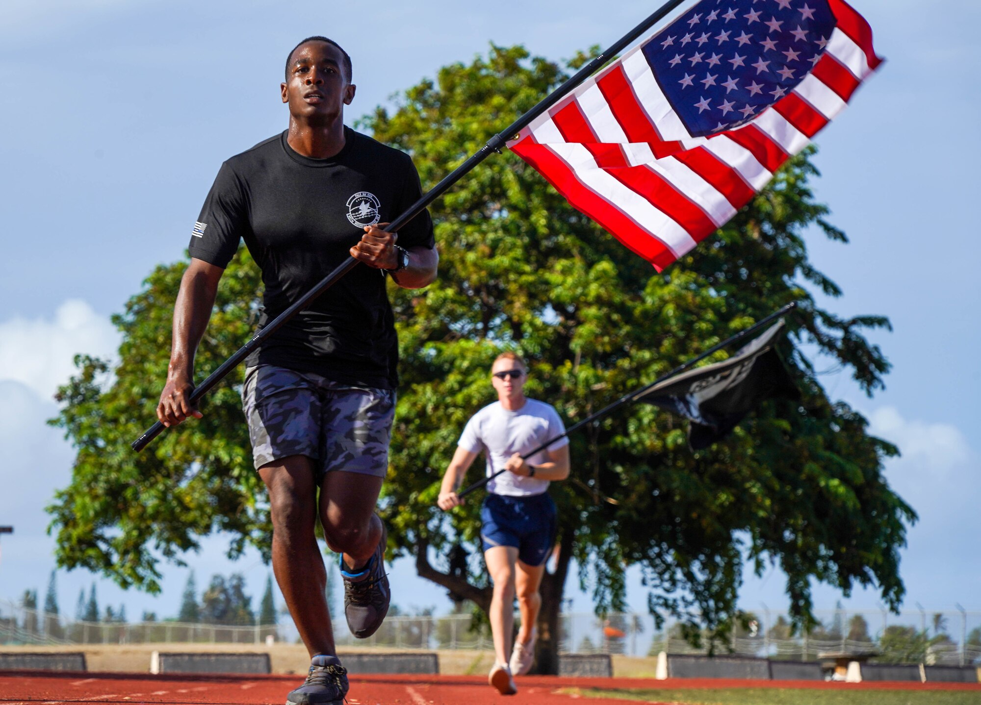 Airman 1st Class Jordan Nettles, 647th Civil Engineer Squadron water and fuels maintenance craftsman, participates in a 24-hour run in honor of Prisoners of War and Missing in Action remembrance week at Joint Base Pearl Harbor-Hickam, Hawaii, Sept. 16, 2021. During the run, the POW/MIA flag will stay in motion for 24 hours by volunteers running with the flag to commemorate and symbolize the unwavering pursuit to recover all service members past and present. (U.S. Air Force photo by Airman 1st Class Makensie Cooper)
