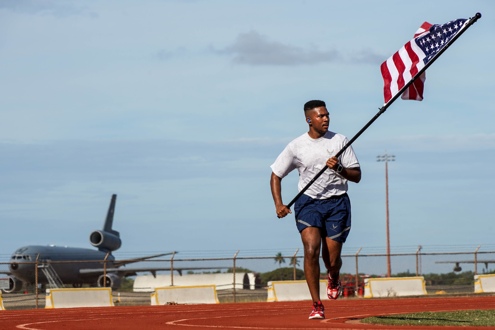 Airman 1st Class Jordan Nettles, 647th Civil Engineer Squadron water and fuels maintenance craftsman, participates in a 24-hour run in honor of Prisoners of War and Missing in Action remembrance week at Joint Base Pearl Harbor-Hickam, Hawaii, Sept. 16, 2021. During the run, the POW/MIA flag will stay in motion for 24 hours by volunteers running with the flag to commemorate and symbolize the unwavering pursuit to recover all service members past and present. (U.S. Air Force photo by Airman 1st Class Makensie Cooper)