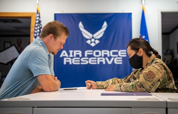 U.S. Air Force Tech. Sgt. Sherry Peoples, 419th Fighter Wing recruiter, reviews enlistment paperwork with Daulton Kvenvold at Hill Air Force Base, Utah