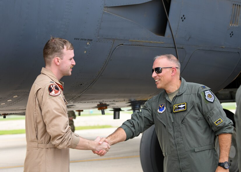 The 5th Bomb Wing vice commander greets a pilot as he returns from deployment