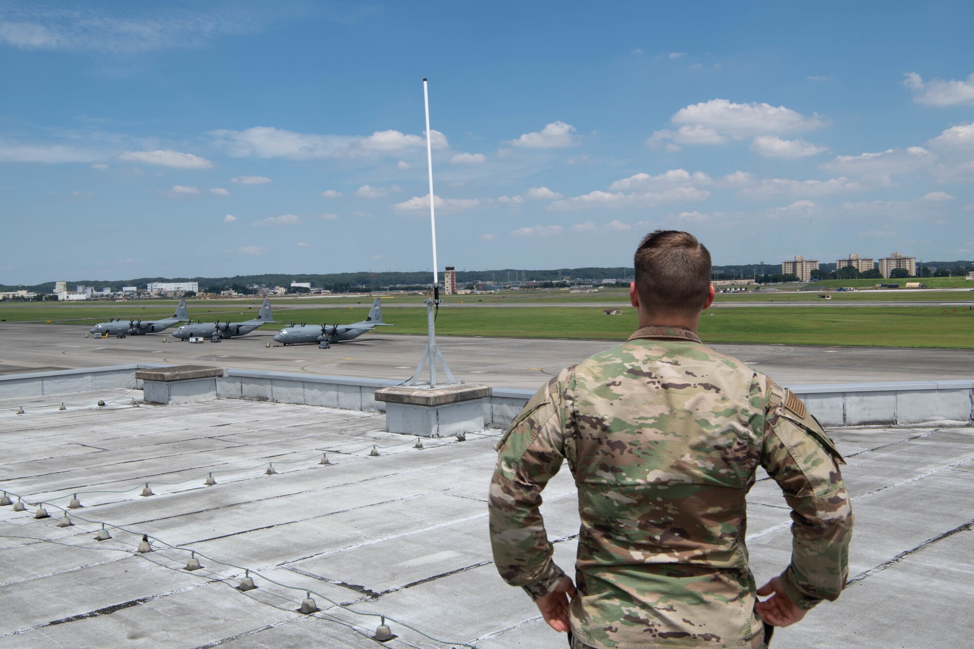 Airman surveys weather sensor.