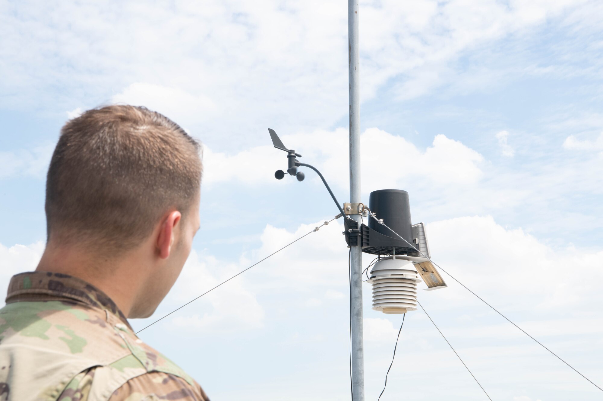 Airman inspects a weather sensor