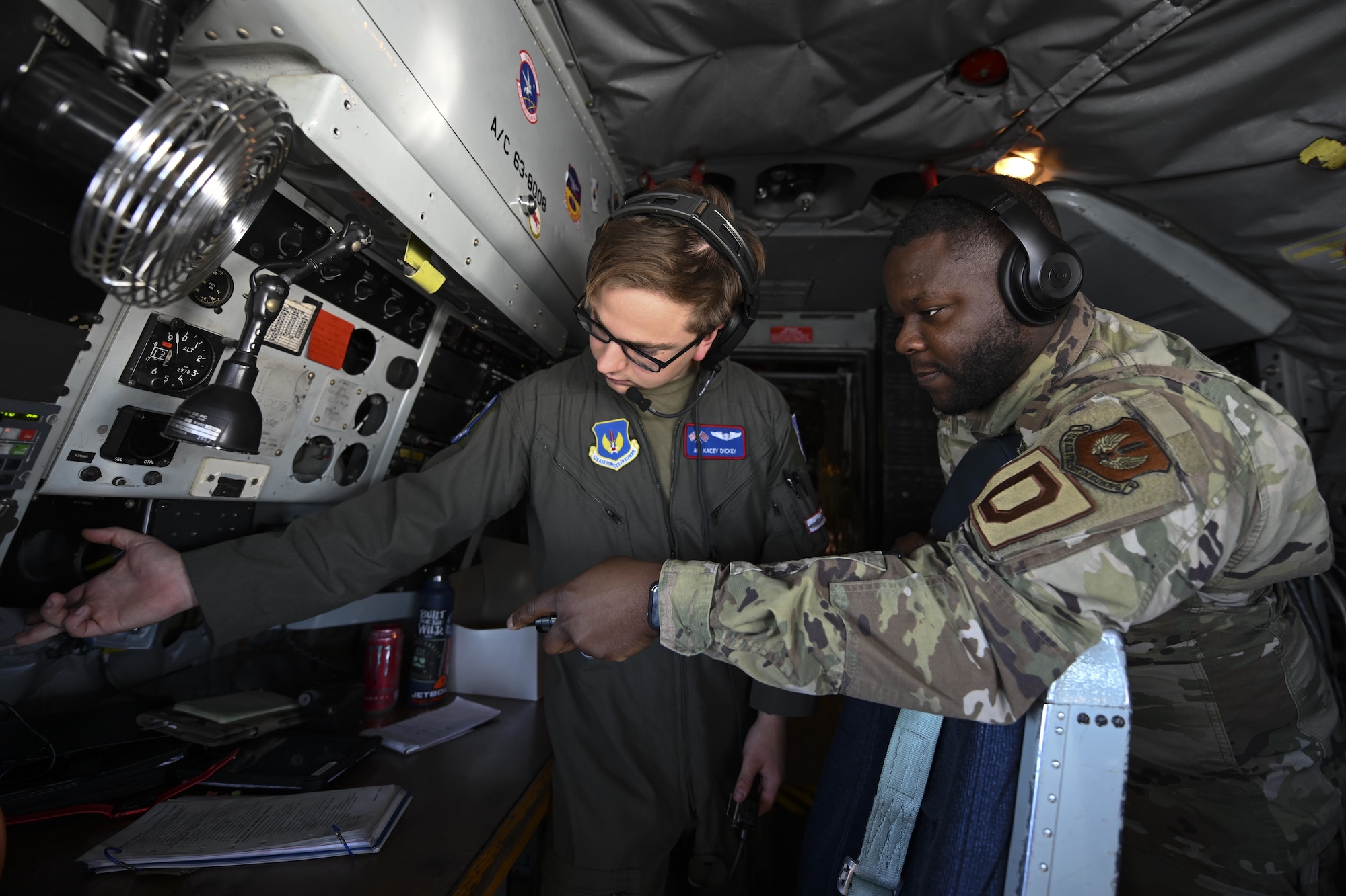 U.S. Air Force Senior Airman Santonio Portis, right, 100th Aircraft Maintenance Squadron electrical and environmental journeyman, and Airman 1st Class Kacey Dickey, 351st Air Refueling Squadron boom operator, troubleshoot a power supply on board a KC-135 Stratotanker aircraft assigned to the 100th Air Refueling Wing, Royal Air Force Mildenhall, England, during exercise High Life over the North Sea, Sept. 15, 2021. The 100th Air Refueling Wing continuously exercises ways to improve its defense capabilities to ensure its advantage in resiliency and to protect its assets and personnel and support its allies. (U.S. Air Force photo by Senior Airman Joseph Barron)