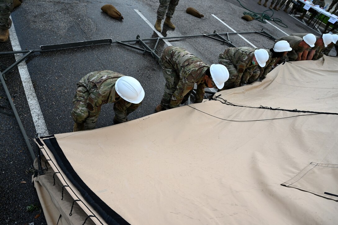 members raise a tent