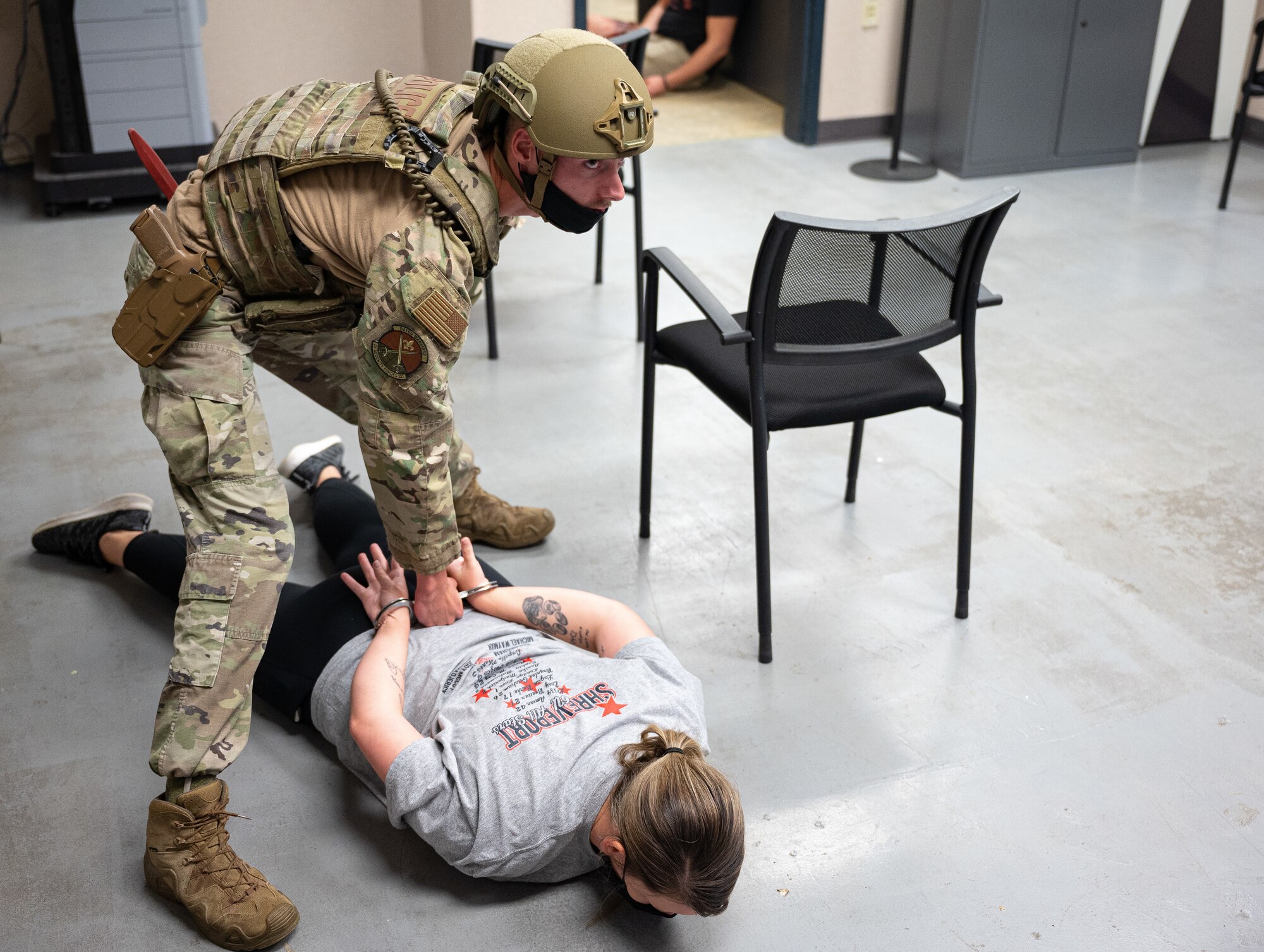 Senior Airman Zachary Burris, 2nd Security Forces Squadron installation patrolman, restrains a hostile actor during an active shooter exercise at Barksdale Air Force Base, Louisiana, Sept. 16, 2021. The exercise was designed to evaluate the training, readiness and capability of Barksdale’s first responders in order to effectively respond to active shooter threats to the installation. (U.S. Air Force photo by Airman 1st Class Jonathan E. Ramos)