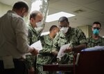 LAFAYETTE, La. - U.S. Navy. Capt. Sean McKay, a physician from Navy Medicine Readiness and Training Command Bethesda and the medical support team senior medical officer, looks over the medical supplies available in the intensive care unit during a tour of Ochsner Lafayette General Medical Center as part of the COVID response operations in Lafayette, Louisiana, Aug. 19, 2021. U.S. Northern Command, through U.S. Army North, remains committed to providing flexible Department of Defense support to the whole-of-government COVID-19 response. (U.S. Navy photo by Mass Communication Specialist 2nd Class Michael H. Lehman/Released)
