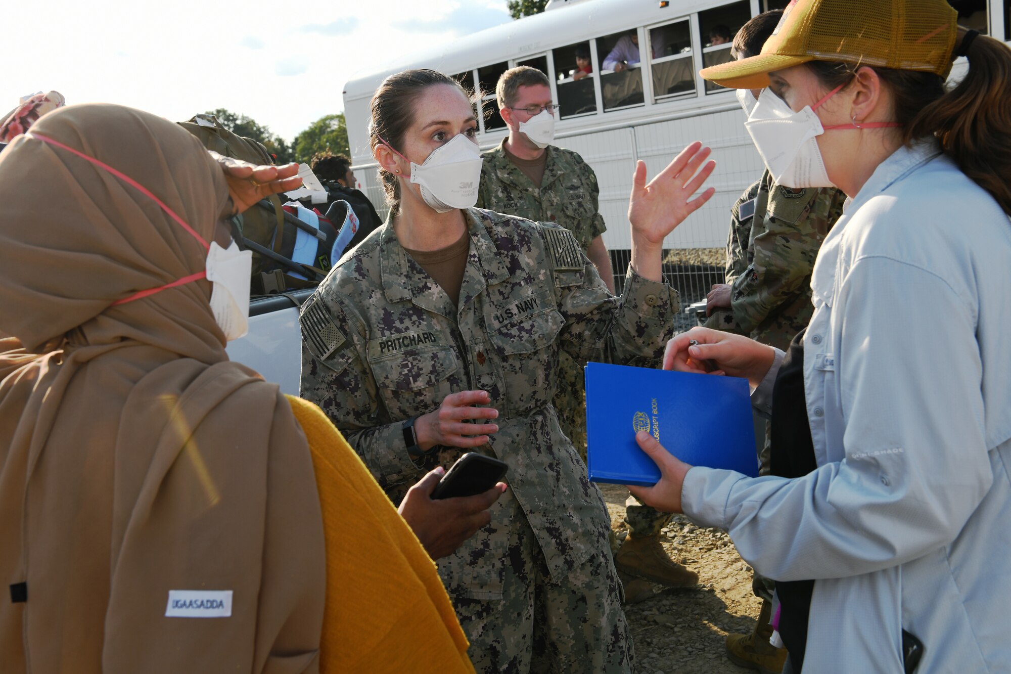 U.S. Navy Lt. Cmdr. Nikki Pritchard, (center) assigned to the Marine Corps Air Ground Combat Center, 29 Palms, San Bernardino, California, and Public Health Lead for Task Force Liberty, interacts with staff members preparing to open the new medical station Liberty Village, Joint Base McGuire-Dix-Lakehurst, New Jersey, Sept. 11, 2021.  The Department of Defense, through U.S. Northern Command, and in support of the Department of Homeland Security, is providing transportation, temporary housing, medical screening, and general support for at least 50,000 Afghan evacuees at suitable facilities, in permanent or temporary structures, as quickly as possible. This initiative provides Afghan personnel essential support at secure locations outside Afghanistan. (National Guard photo by Master Sgt. John Hughel, Washington Air National Guard)