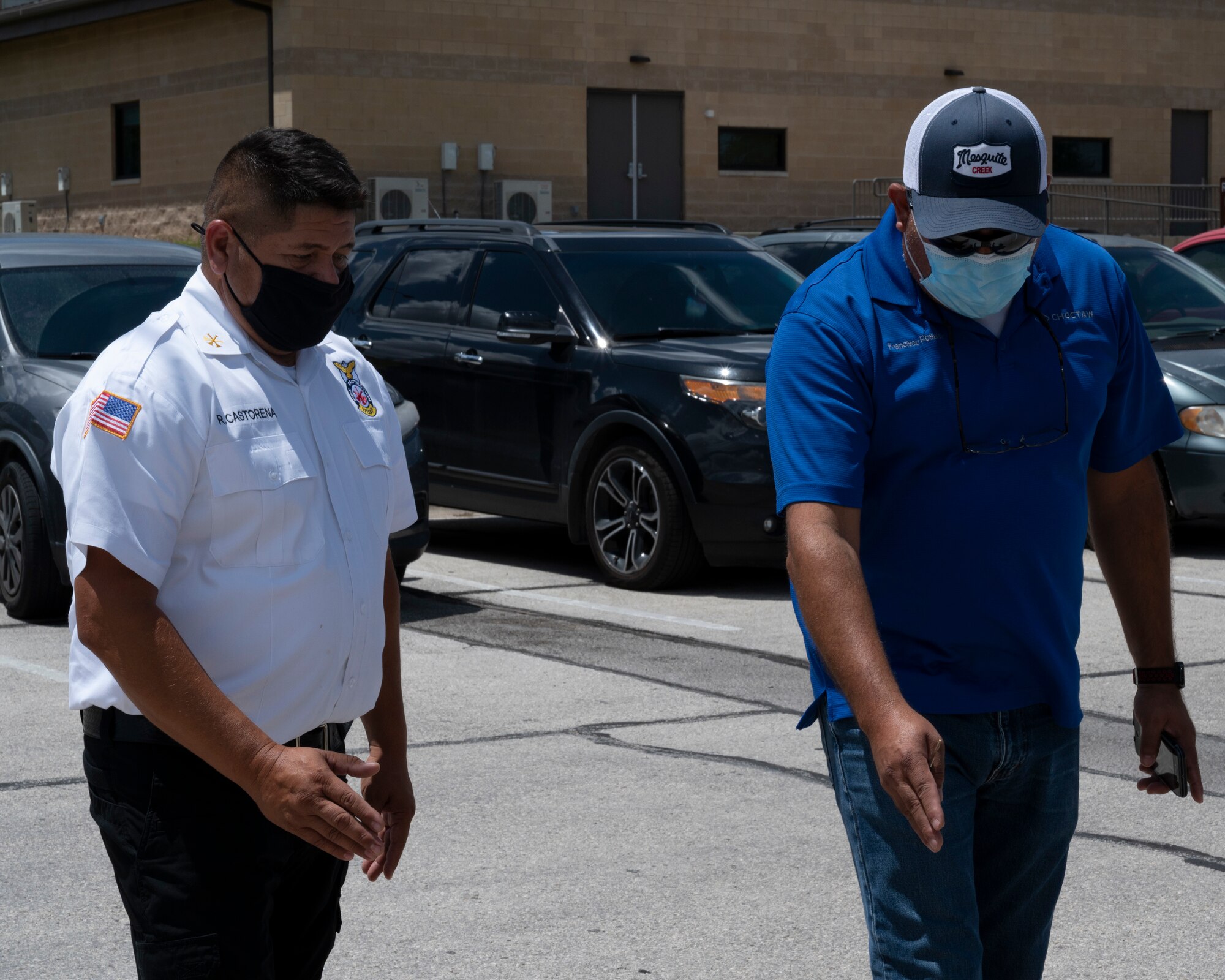 Raul Castorena, 47th Civil Engineering Squadron assistant fire chief, talks with a contractor about painting new lines outside of the Laughlin Air Force Base firestation on August 25, 2021. The lines to be painted will help improve safety and parking outside of the firestation. (U.S. Air Force Photo by Senior Airman Nicholas Larsen)