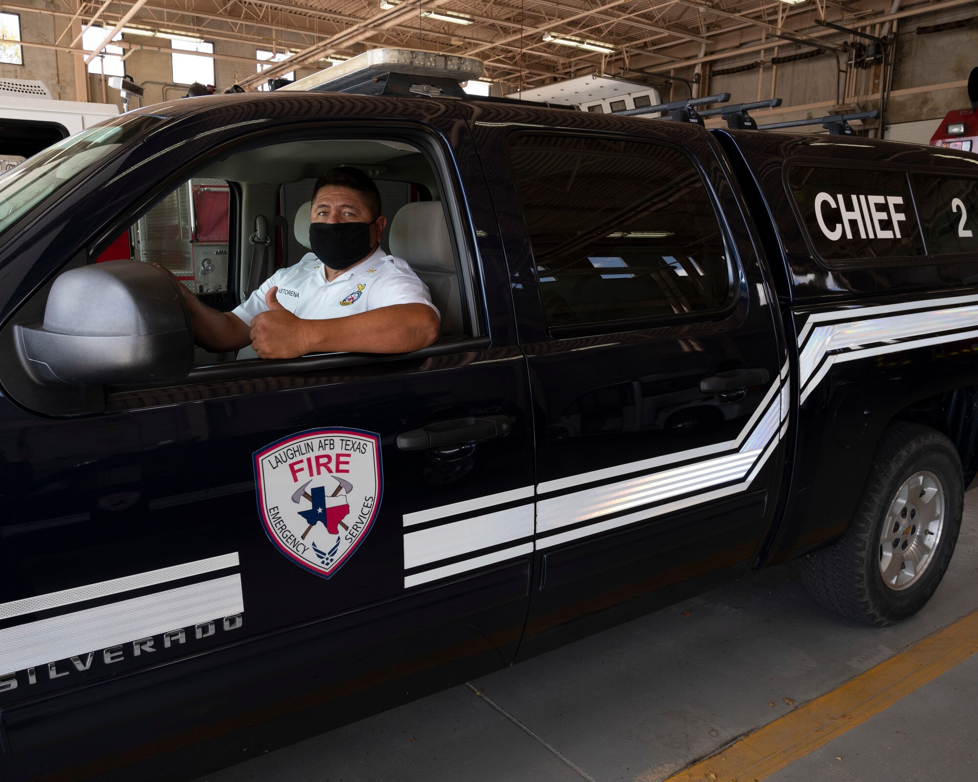 Raul Castorena, 47th Civil Engineering Squadron assistant fire chief, poses in his command truck at the Laughin Air Force Base Fire Station on August 25, 2021. The chief command truck allows for the fire chief to better get around and respond to emergencies on base. (U.S. Air Force Photo by Senior Airman Nicholas Larsen)