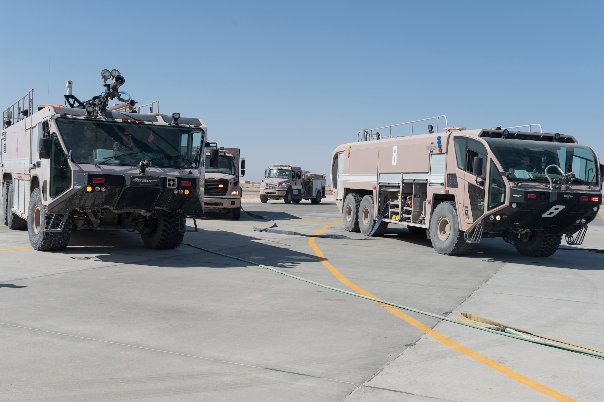 U.S. Airmen with the 332nd Expeditionary Medical Group and the 332nd Expeditionary Civil Engineering Squadron participate in a rescue exercise for a simulated aircraft fire