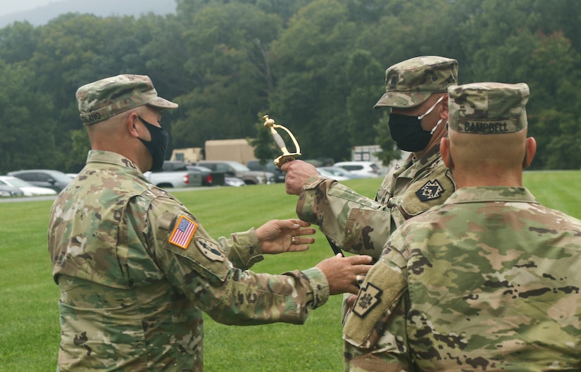 Soldiers with the 213th Regional Support Group gathered at Strickler Field on Fort Indiantown Gap Sept. 17 to witness the transfer responsibility from Command Sgt. Maj. Andrew Campbell to Command Sgt. Maj. Marc Weiss in a traditional ceremony. To symbolize the transfer of responsibility, a ceremonial sword was passed from Campbell, to 213th RSG commander Col. Angelo Catalano, who then passed it to Weiss. (U.S. Army National Guard photo by Staff Sgt. Zane Craig)
