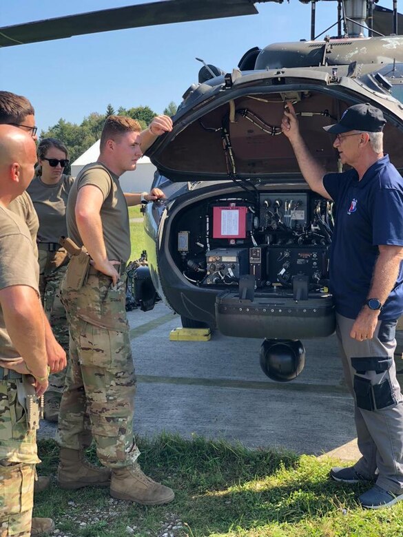 James Scism, a U.S. Army Aviation and Missile Command Logistics Assistance Representative assigned to the 405th Army Field Support Brigade, provides technical training to Soldiers with C Company's MEDEVAC flight crew from 2nd General Support Aviation Battalion, 1st Combat Aviation Brigade, while supporting Saber Junction 21 at Hohenfels Training Area, Germany, Sept. 14. (U.S. Army Courtesy photo)