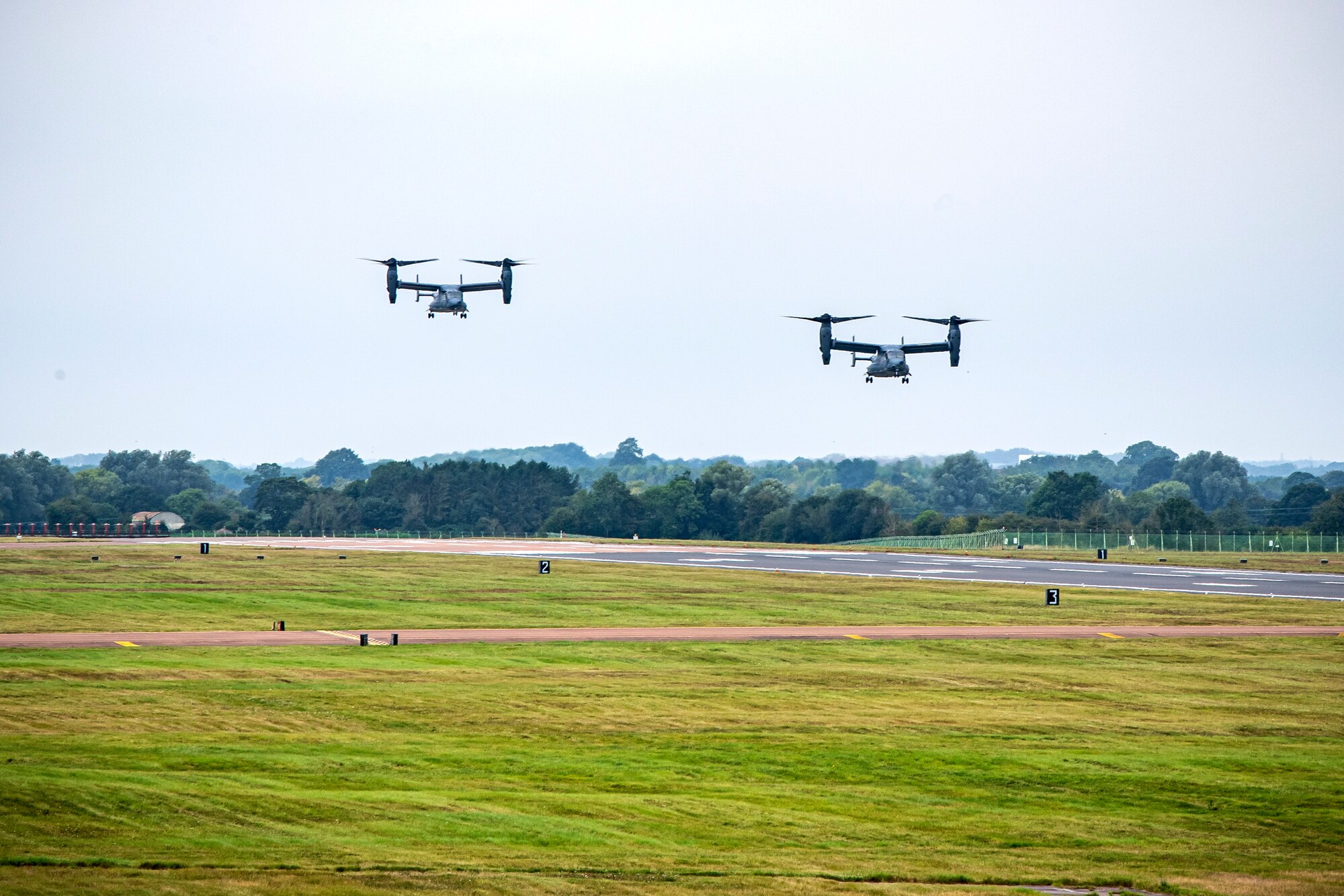 Two CV-22A Ospreys assigned to the 352d Special Operations Wing approach for landing during an Agile Combat Employment exercise at RAF Fairford, England, Sept. 13, 2021. Airmen from the 501st Combat Support Wing, 100th Air Refueling Wing and 352d SOW partnered to conduct an ACE exercise to test their overall readiness and lethality capabilities. ACE ensures Airmen and aircrews are postured to deliver lethal combat power across the full spectrum of military operations. (U.S. Air Force photo by Senior Airman Eugene Oliver)