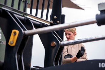 An aircrew member from the 352d Special Operations Wing directs the movement of cargo during an Agile Combat Employment exercise at RAF Fairford, England, Sept. 13, 2021. Airmen from the 501st Combat Support Wing, 100th Air Refueling Wing and 352d SOW partnered to conduct an ACE exercise to test their overall readiness and lethality capabilities. The exercise enables U.S. forces in Europe to operate from locations with varying levels of capacity and support. (U.S. Air Force photo by Senior Airman Eugene Oliver)