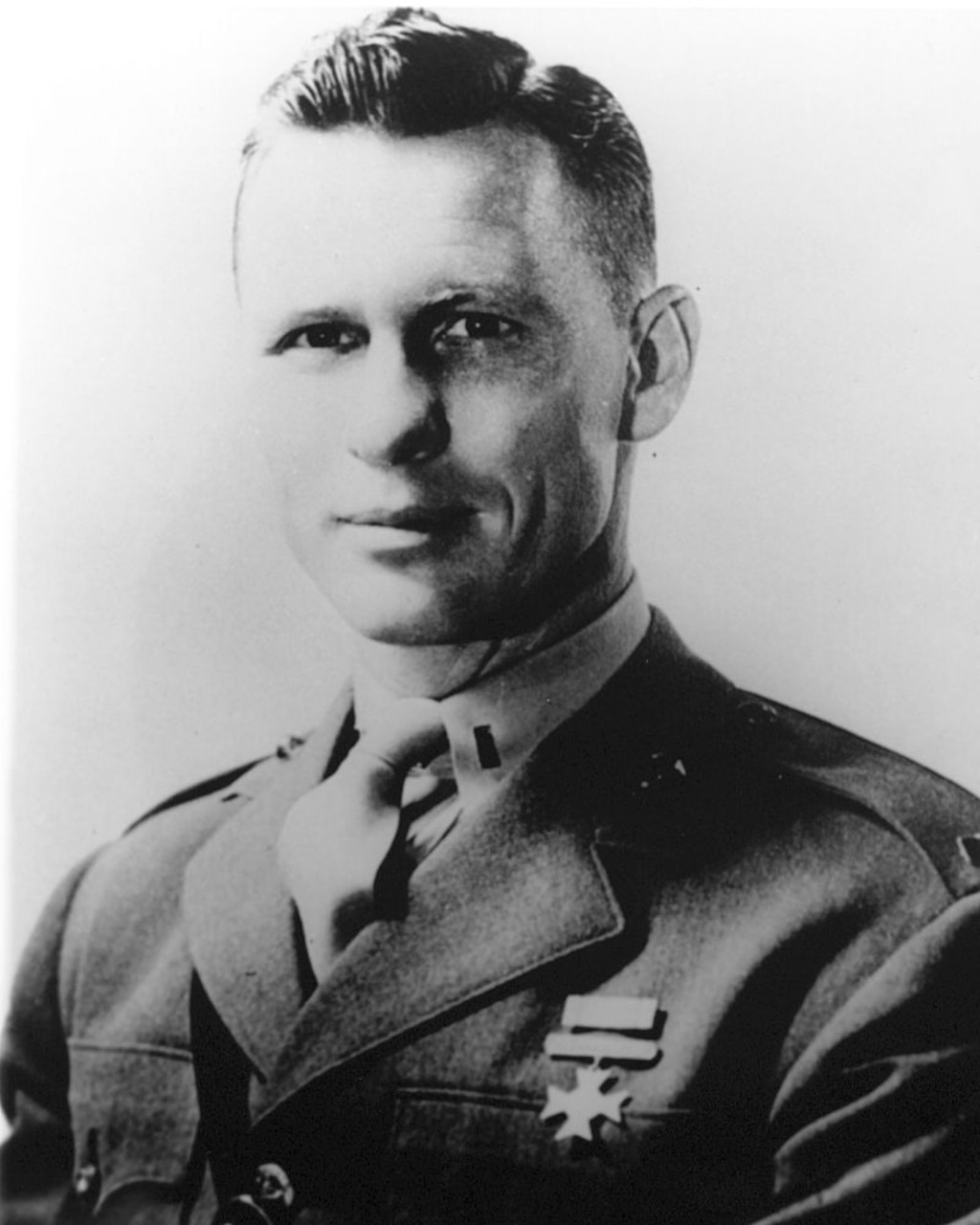 Man in uniform poses for photo.