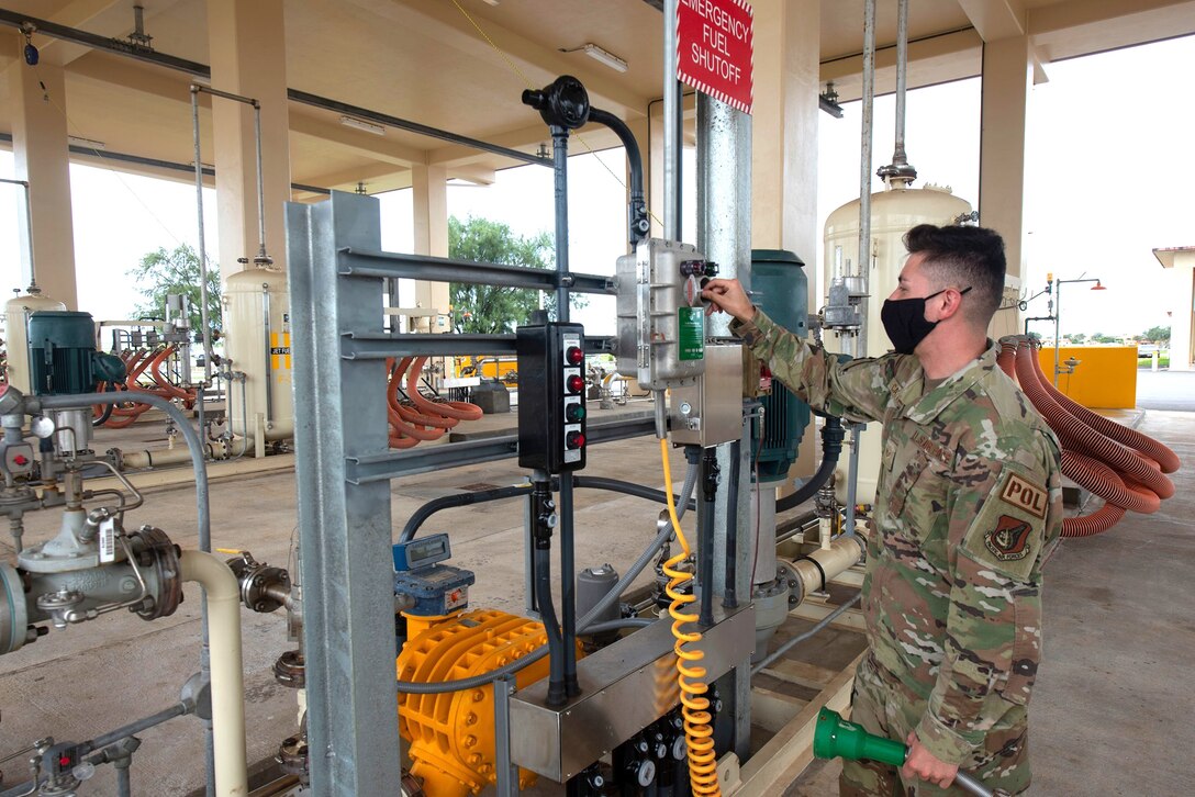 a military member tests a fuel pump