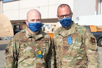 U.S. Air Force Master Sgt. Ron Murray, left, 501st Combat Support Wing Chapel superintendent of religious affairs, and Chaplain Capt. Steven Davis, right, 501st CSW Chapel, provide religious and counseling support in POD 2 at Ramstein Air Base, Germany, Sept. 1, 2021. Airmen from the 501st CSW chapel integrated with Ramstein’s chapel team and supported the religious and spiritual needs of the evacuees, Airmen, Soldiers, joint allied forces and volunteers. The team provided stewardship for 16 mosques, supplied over 500 prayer rugs, assisted with trash pickup and food distribution and delivered refreshments to workers and volunteers. They also provided counseling and guidance to Airmen in dealing with and metabolizing all their experiences from a cultural and religious perspective. (U.S. Air Force photo by Senior Airman Jennifer Zima)