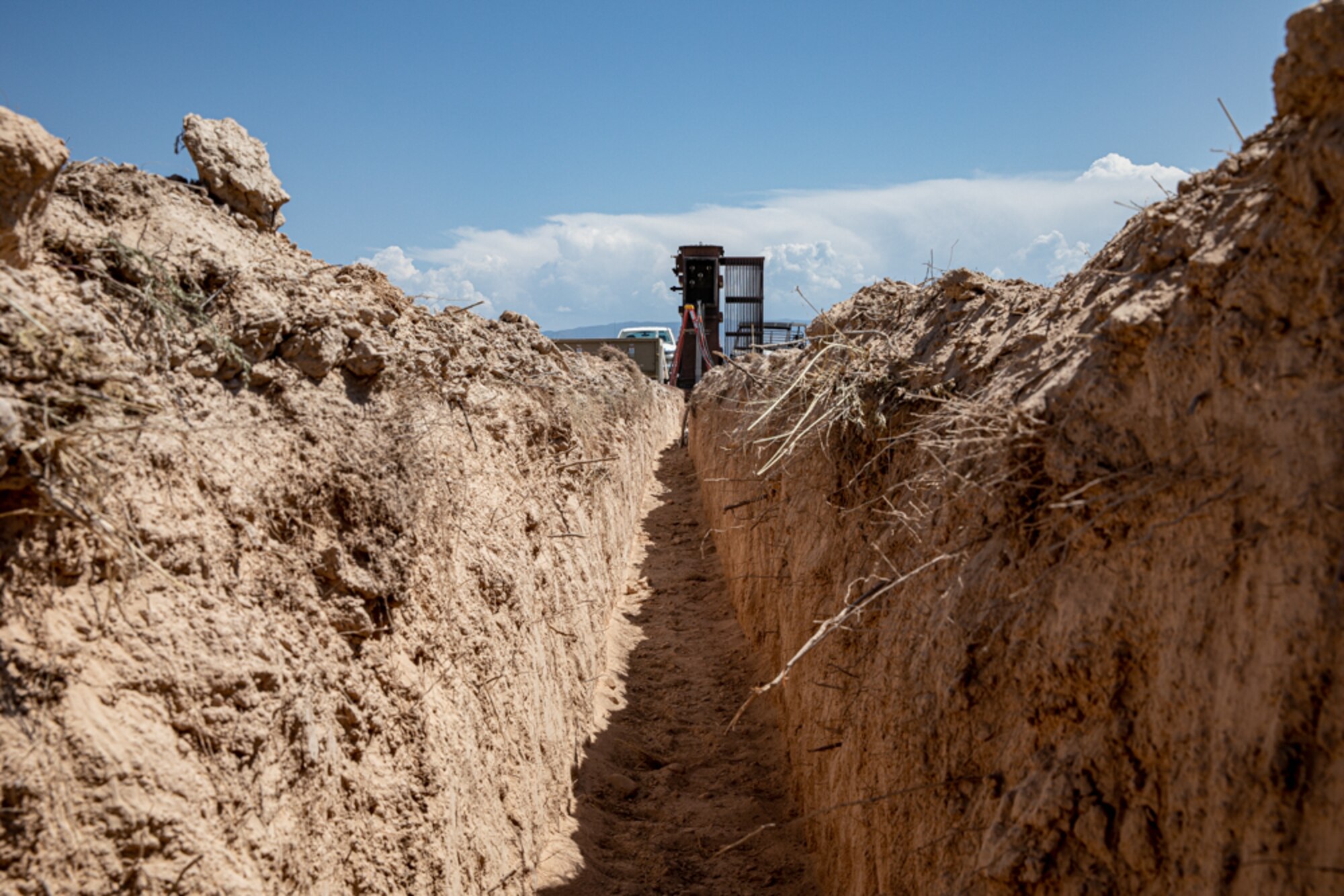 Task Force-Holloman Airmen deployed from the 820th RED HORSE Squadron at Nellis Air Force Base, Nevada, dug an open area in the ground for electrical cables to be placed for future constructs as part of Operation Allies Welcome Sept. 16, 2021 on Holloman Air Force Base, New Mexico. The Department of Defense, through the U.S. Northern Command, and in support of the Department of State and Department of Homeland Security, is providing transportation, temporary housing, medical screening, and general support for at least 50,000 Afghan evacuees at suitable facilities, in permanent or temporary structures, as quickly as possible. This initiative provides Afghan evacuees essential support at secure locations outside Afghanistan. (U.S. Army photo by Spc. Nicholas Goodman)