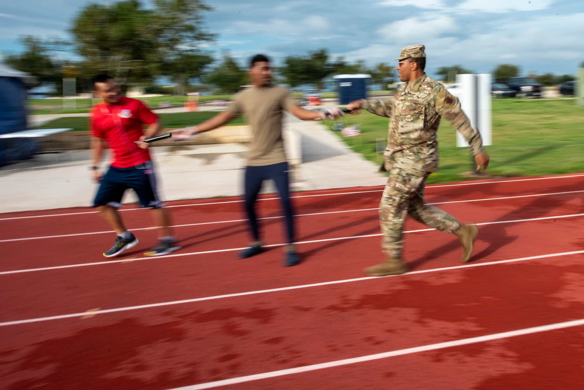 Men run relay on track