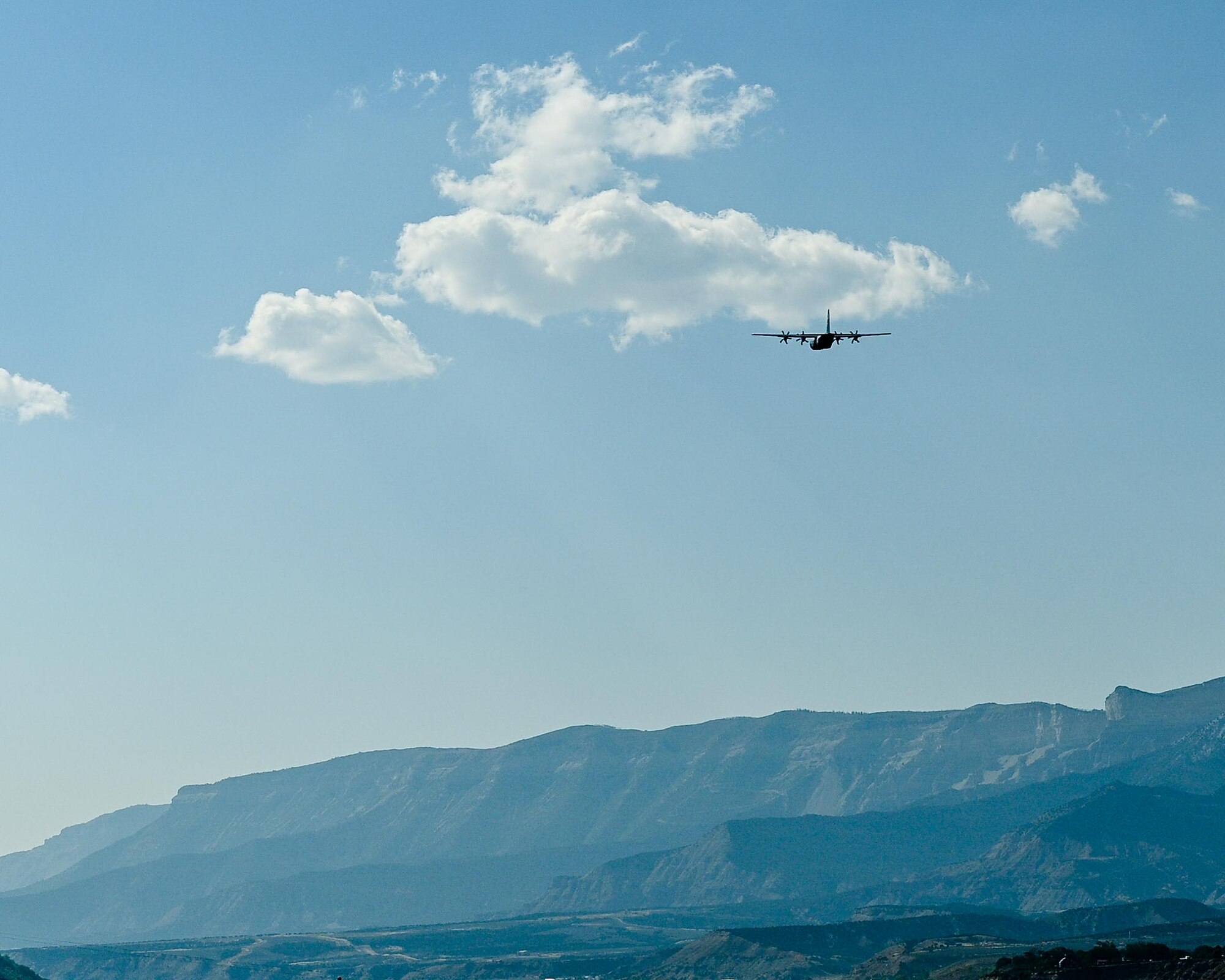 cargo aircraft in the sky above mountains