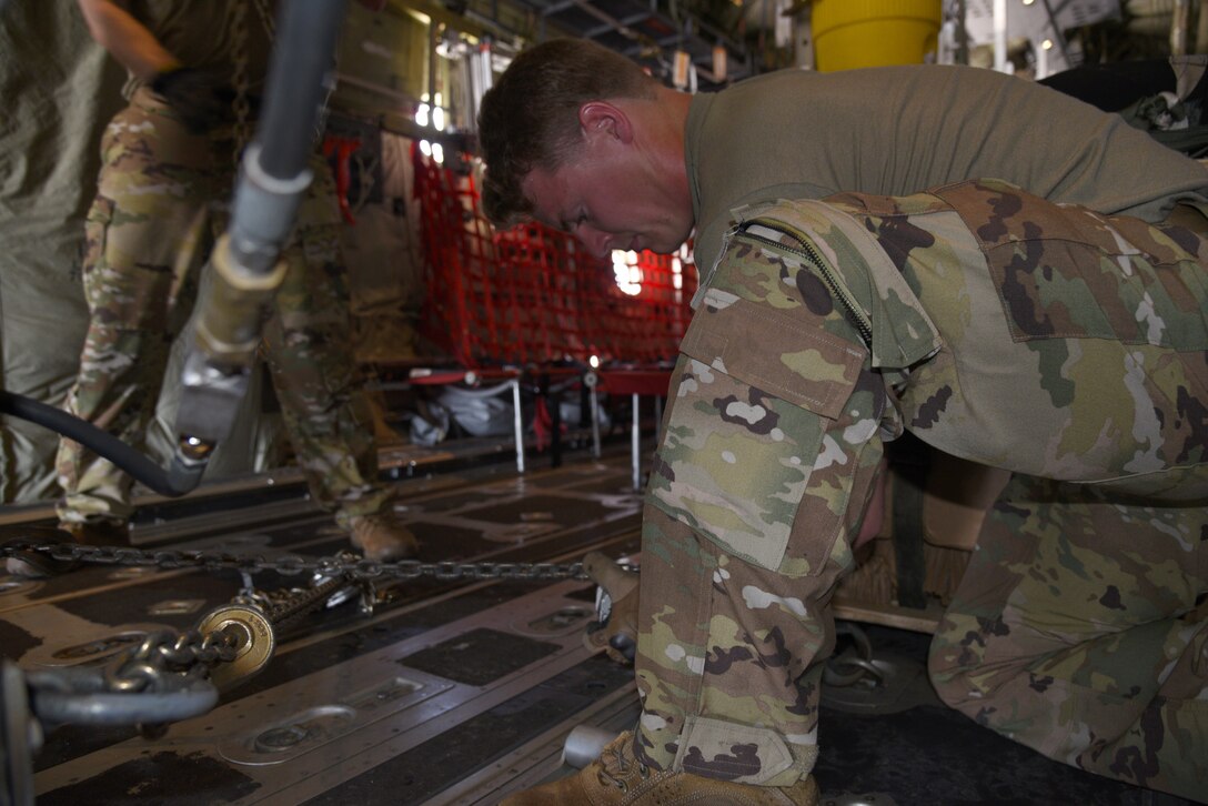 Staff Sgt. James Walker, 815th Airlift Squadron loadmaster, ties down the equipment loaded on board the C-130J Super Hercules, before it was transported from Peterson Space Force Base, Colorado to Rifle-Garfield County Airport, Rifle, Colorado for use during the 22nd Air Force’s flagship exercise Rally in the Rockies Sept. 13-17, 2021. The exercise is designed to develop Airmen for combat operations by challenging them with realistic scenarios that support a full spectrum of operations during military actions, operations or hostile environments. (U.S. Air Force photo by Master Sgt. Jessica Kendziorek)
