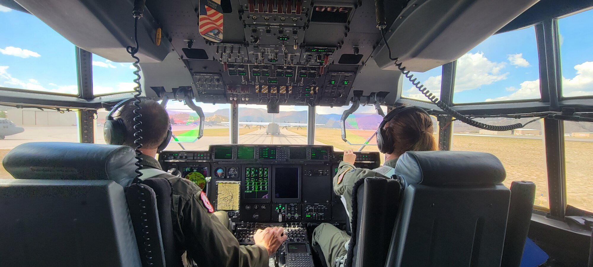 Maj. Nick Foreman and Lt. Col. Stephanie Brown, 815th Airlift Squadron pilots, prepare for take-off in the C-130J Super Hercules before the airdrop in Taylor Park, Colorado, while they take part in the 22nd Air Force’s flagship exercise Rally in the Rockies Sept. 13-17, 2021. The exercise is designed to develop Airmen for combat operations by challenging them with realistic scenarios that support a full spectrum of operations during military actions, operations or hostile environments. (U.S. Air Force photo by Capt. Will Garey)
