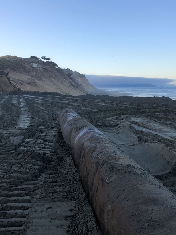 Sand stretching outward to the ocean.