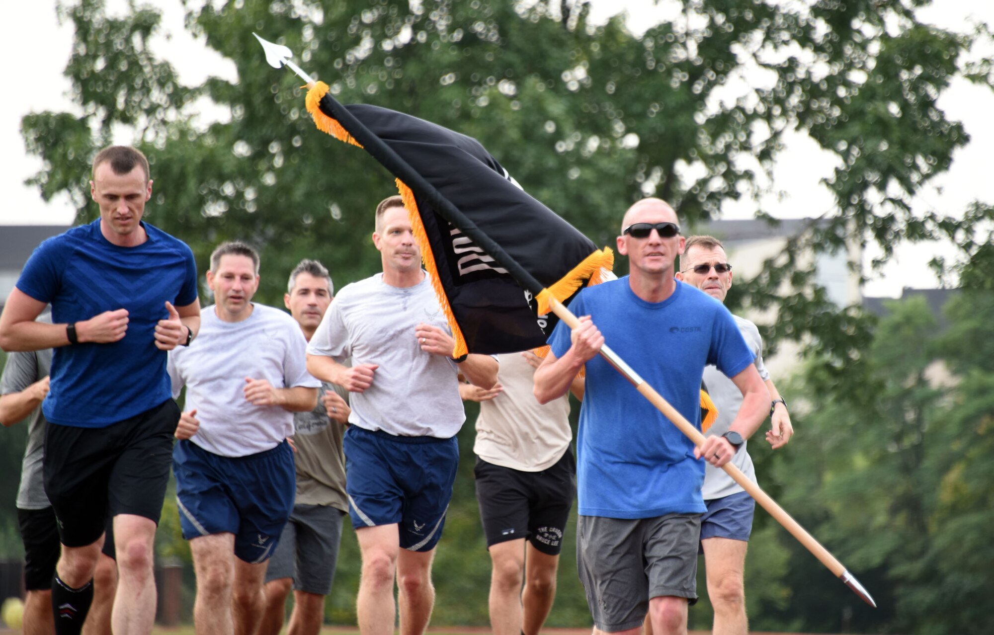 305th AMW runs around gym track.