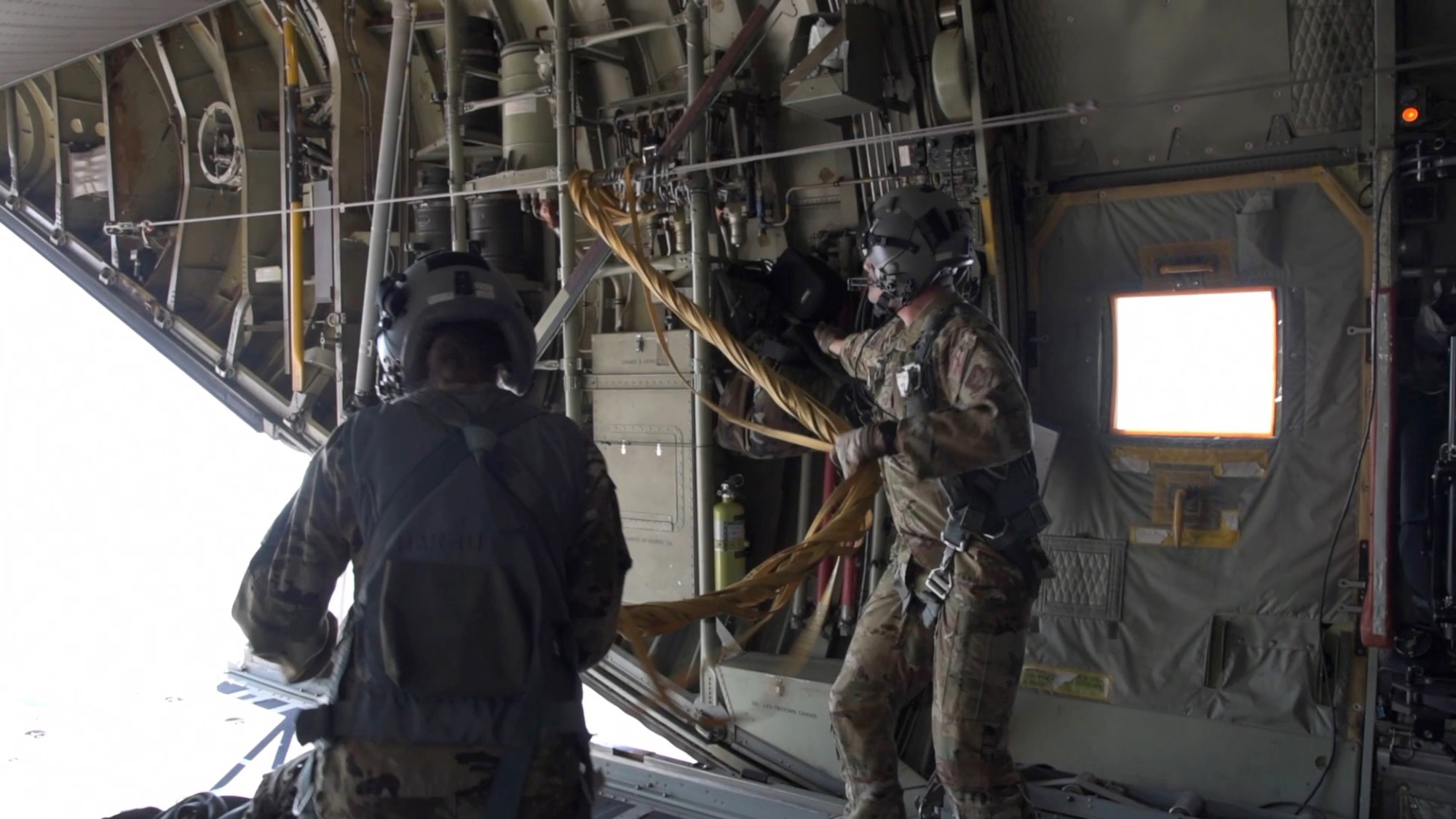 Senior Master Sgt. Robert Mitchell, and Senior Airman Kaleb Walker, 757th Airlift Squadron loadmasters, pull the parachute bags into the aircraft after paratroopers static line jump from the C-130H Hercules during the 22nd Air Force’s flagship exercise Rally in the Rockies Sept. 13-17, 2021. The exercise is designed to develop Airmen for combat operations by challenging them with realistic scenarios that support a full spectrum of operations during military actions, operations or hostile environments. (U.S. Air Force photo by Master Sgt. Jessica Kendziorek)