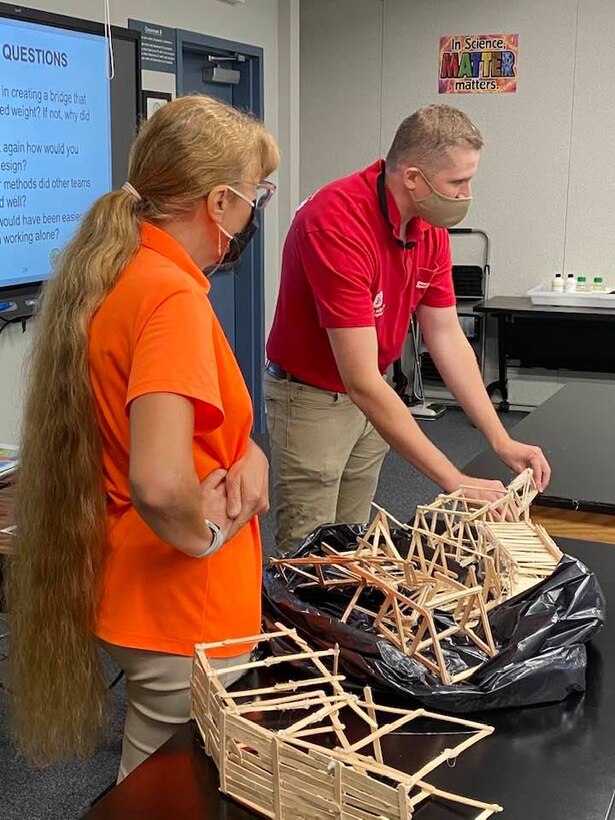 TAM civil engineer Garrison Myer points out the benefits of examining what happened after testing and improving your design for future efforts. All the students now know that the triangle is better for holding weight than rectangles.