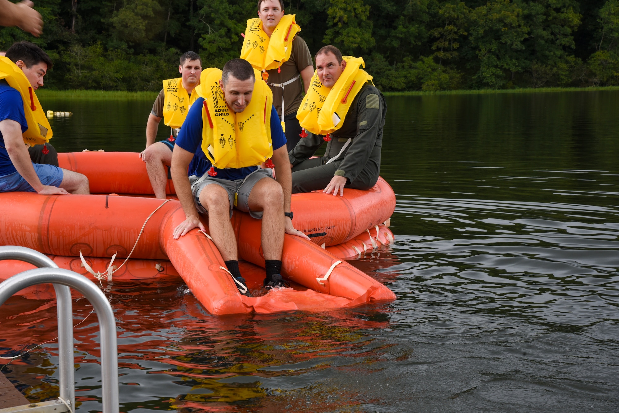 An airman prepares to go into the water during water survival training.