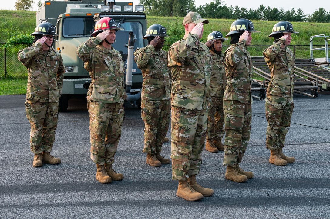 Members of the 932nd Civil Engineering Squadron, salute during a 9/11 remembrance ceremony, Scott Air Force Base, Illinois, Sept. 11, 2021. 932nd CES held a remembrance ceremony with the symbolic “Ringing of the Fire Department Bell”, to honor the fallen. (U.S. Air Force Photo by Staff Sgt. Brooke Spenner)
