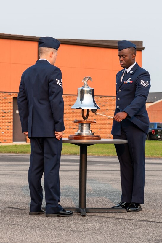 Members of the 932nd Fire and Emergency Services Flight conduct the symbolic “Ringing of the Fire Department Bell”, during a 9/11 remembrance ceremony, Scott Air Force Base, Illinois, Sept. 11, 2021. To symbolize the devotion these brave souls had for their duty a special signal of three rings, three times each, represents the end of our comrades duties that they will be returning to quarters. (U.S. Air Force Photo by Staff Sgt. Brooke Spenner)