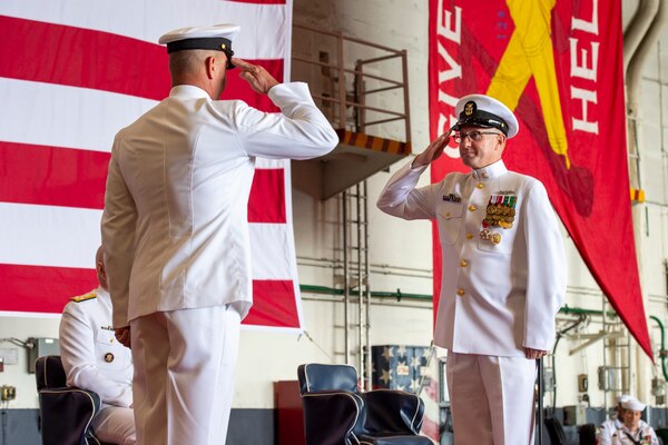 U.S. Fleet Forces Command Fleet Master Chief Rick O'Rawe, right, salutes his relief, Fleet Master Chief John Perryman, during his retirement ceremony on board USS Harry S. Truman (CVN 75) in Norfolk, Va,