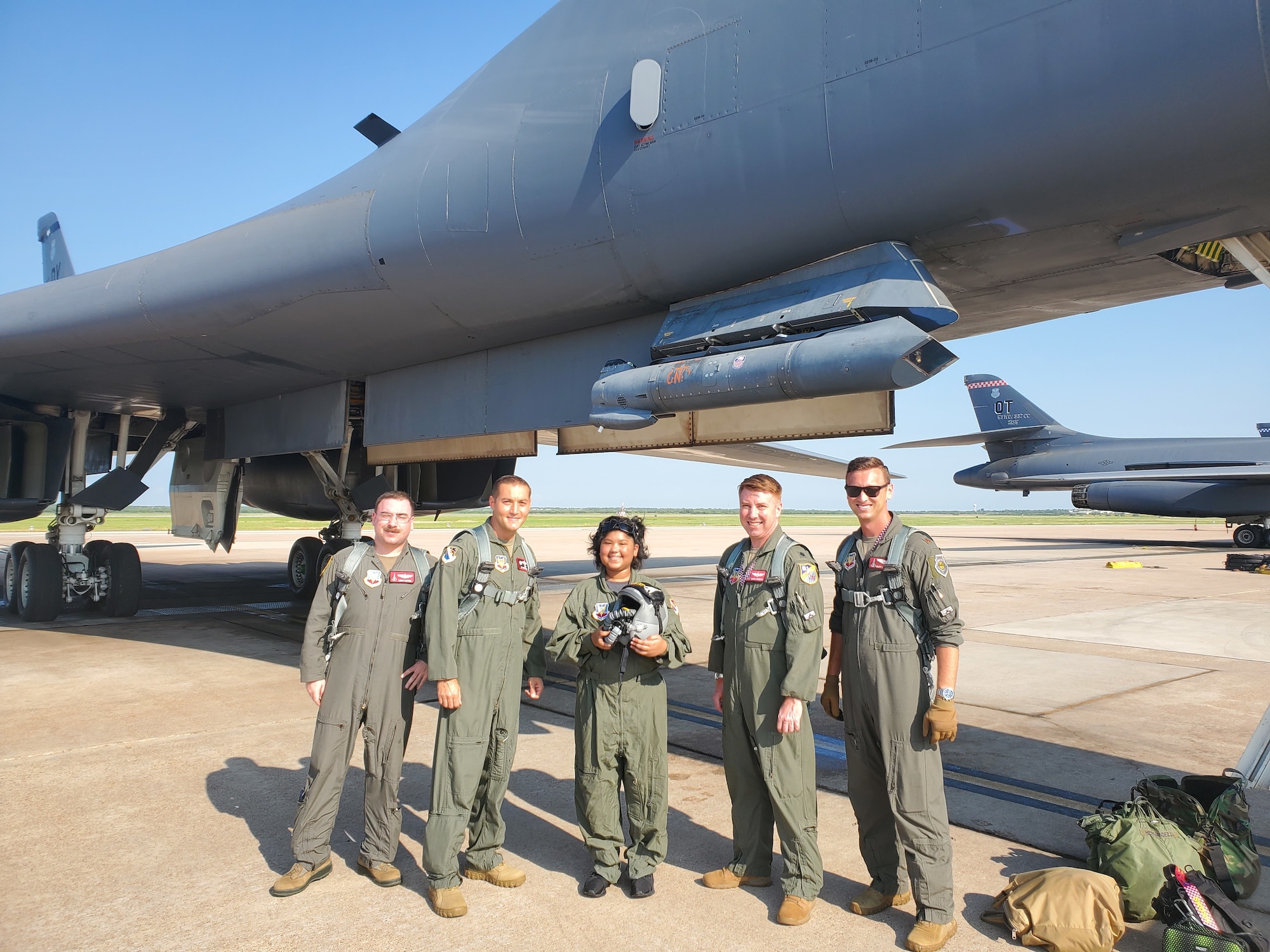 From left to right, Maj. Matthew Sutton, 337th Test and Evaluation Squadron director of test, Col. Jaime Hernandez, 53rd Test Management Group commander, Jayda SoileauGobert, Tech. Sgt. Justin SoileauGobert’s daughter, Lt. Col. Thomas Kinnear, 337th TES director of operations, and Maj. Mike Costello, 337th TES chief of weapons and tactics, pose for a group photo at Dyess Air Force Base, Texas, July 7, 2021.