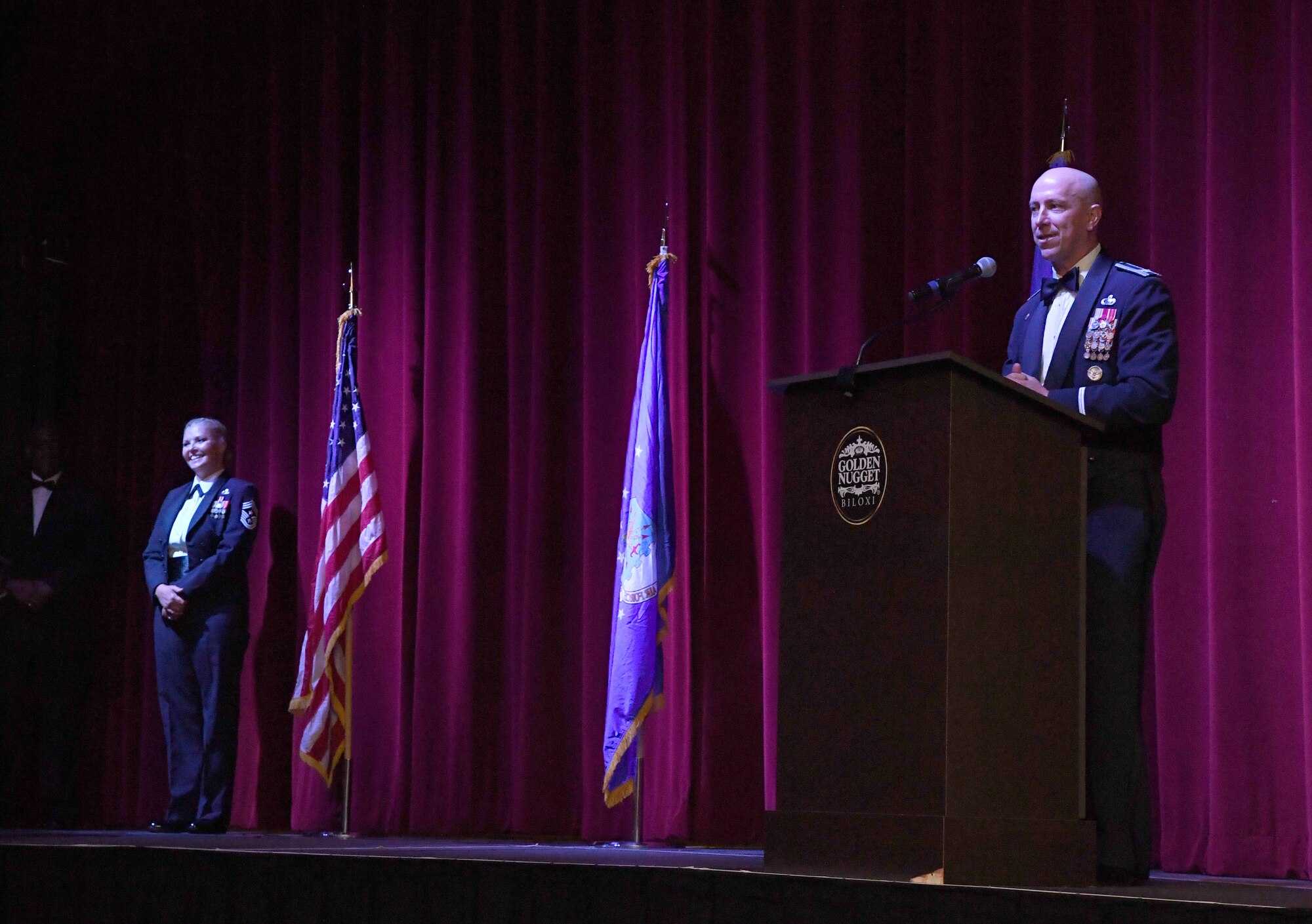 U.S. Air Force Col. William Hunter, 81st Training Wing commander, delivers remarks while Chief Master Sgt. Sarah Esparza, 81st TRW command chief, stands by during the Keesler Air Force Ball inside the Golden Nugget Casino, Biloxi, Mississippi, Sept. 18, 2021. The event, which celebrated the Air Force�s 74th birthday, also included a cake cutting ceremony. (U.S. Air Force photo by Kemberly Groue)