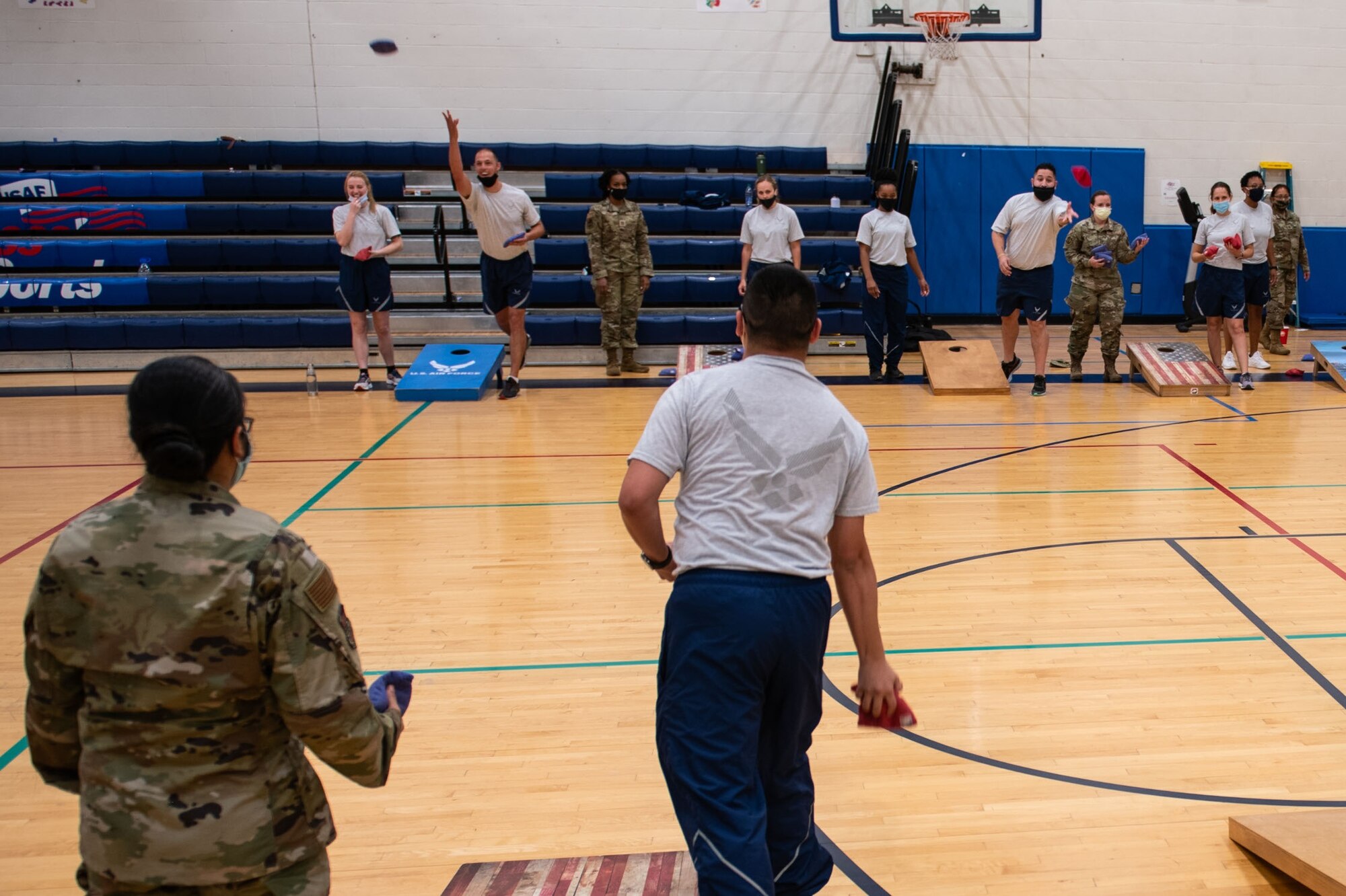 Members of the 932nd Medical Group participate in the corn hole activity during their annual sexual assault prevention and response/suicide prevention training, Scott Air Force Base, Illinois, Sept. 12, 2021. Each activity reviewed the training material, for example during the fit to fight activity a team of airman would be asked a training question and if answered correctly all other groups would do an exercise. (U.S. Air Force Photo by Staff Sgt. Brooke Spenner)
