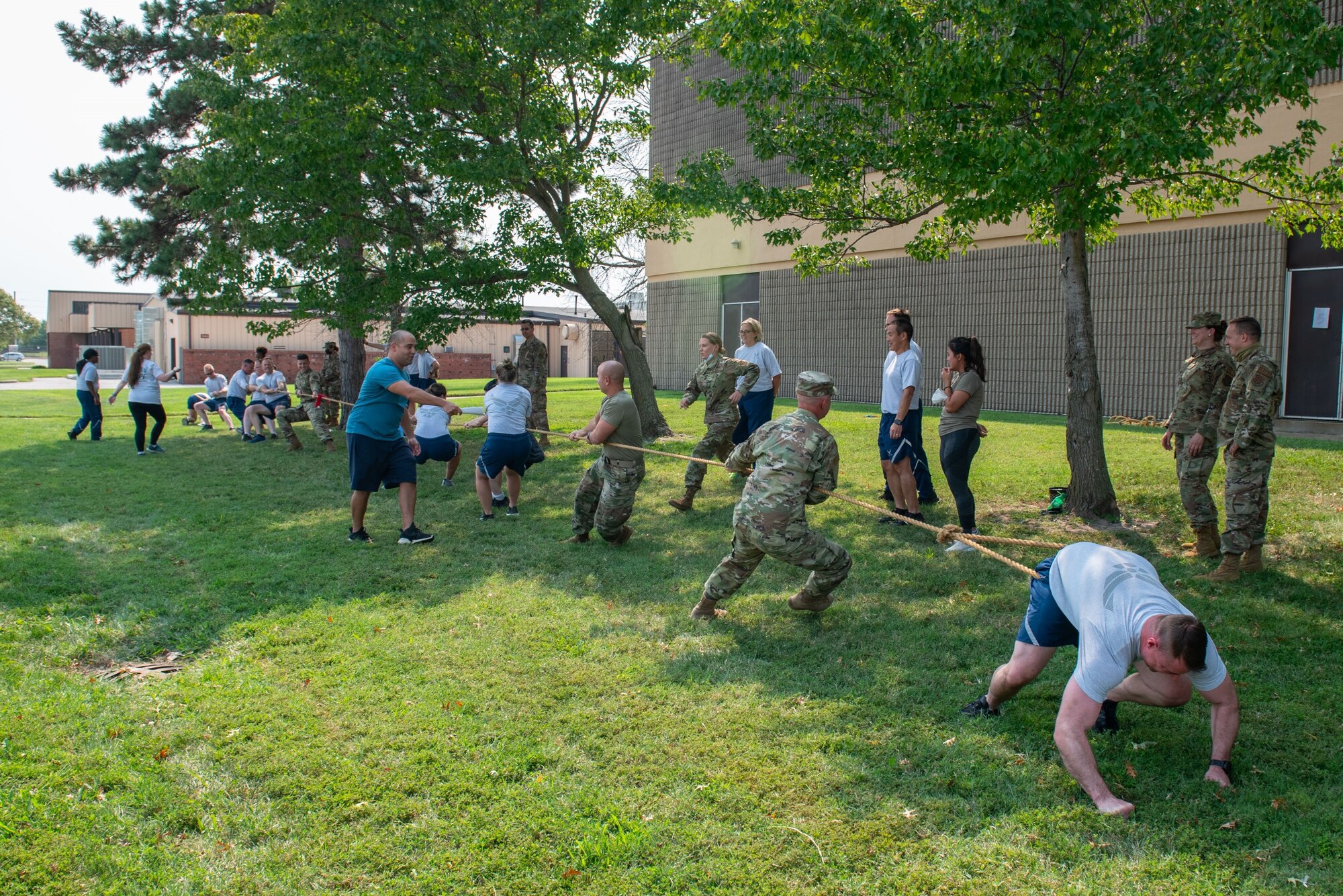 Members of the 932nd Medical Group participate in the tug of war activity during their annual sexual assault prevention and response/suicide prevention training, Scott Air Force Base, Illinois, Sept. 12, 2021. Each activity reviewed the training material, for example during the fit to fight activity a team of airman would be asked a training question and if answered correctly all other groups would do an exercise. (U.S. Air Force Photo by Staff Sgt. Brooke Spenner)