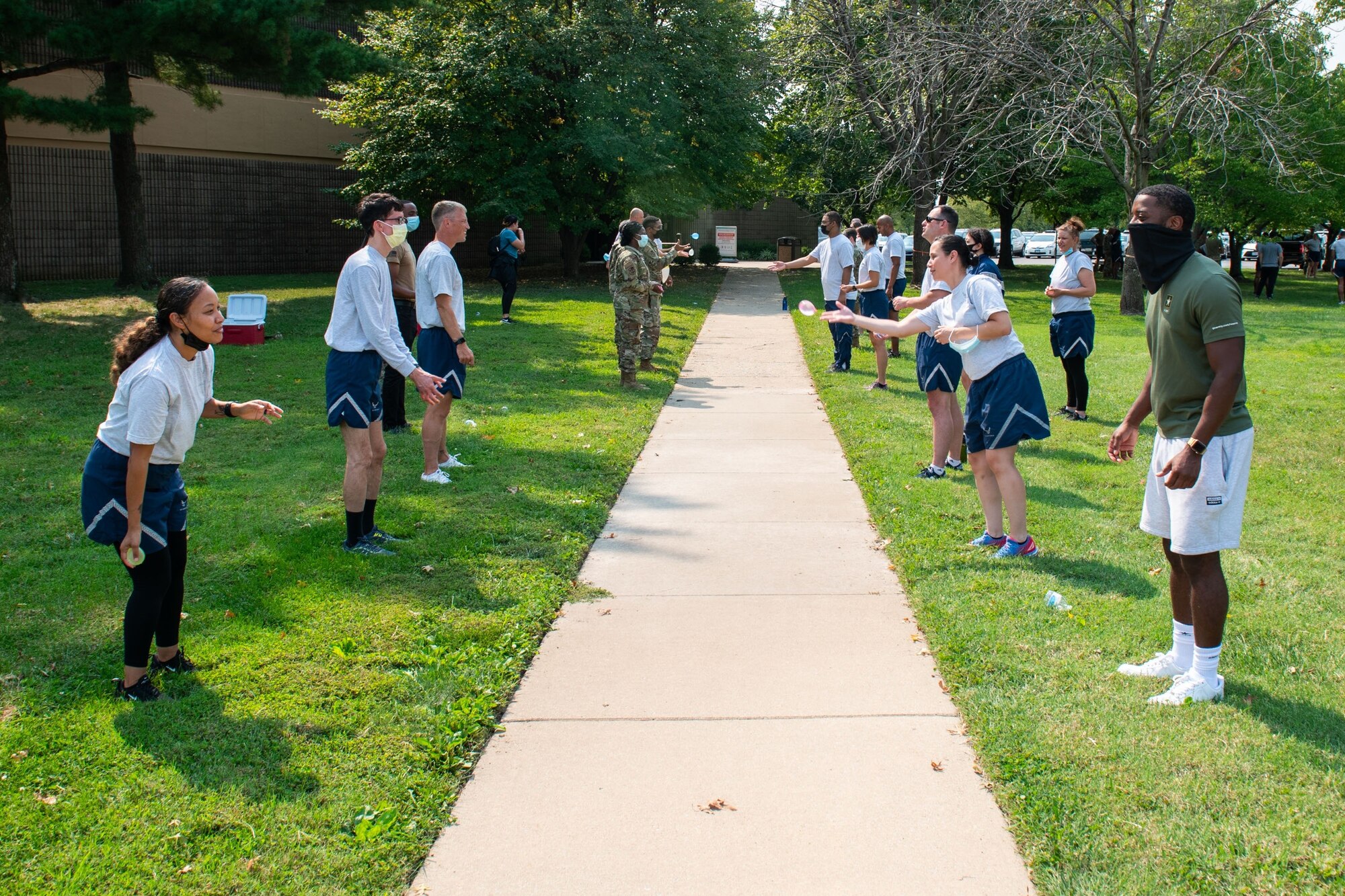 Members of the 932nd Medical Group participate in the water balloon toss activity during their annual sexual assault prevention and response/suicide prevention training, Scott Air Force Base, Illinois, Sept. 12, 2021. Each activity reviewed the training material, for example during the fit to fight activity a team of airman would be asked a training question and if answered correctly all other groups would do an exercise. (U.S. Air Force Photo by Staff Sgt. Brooke Spenner)
