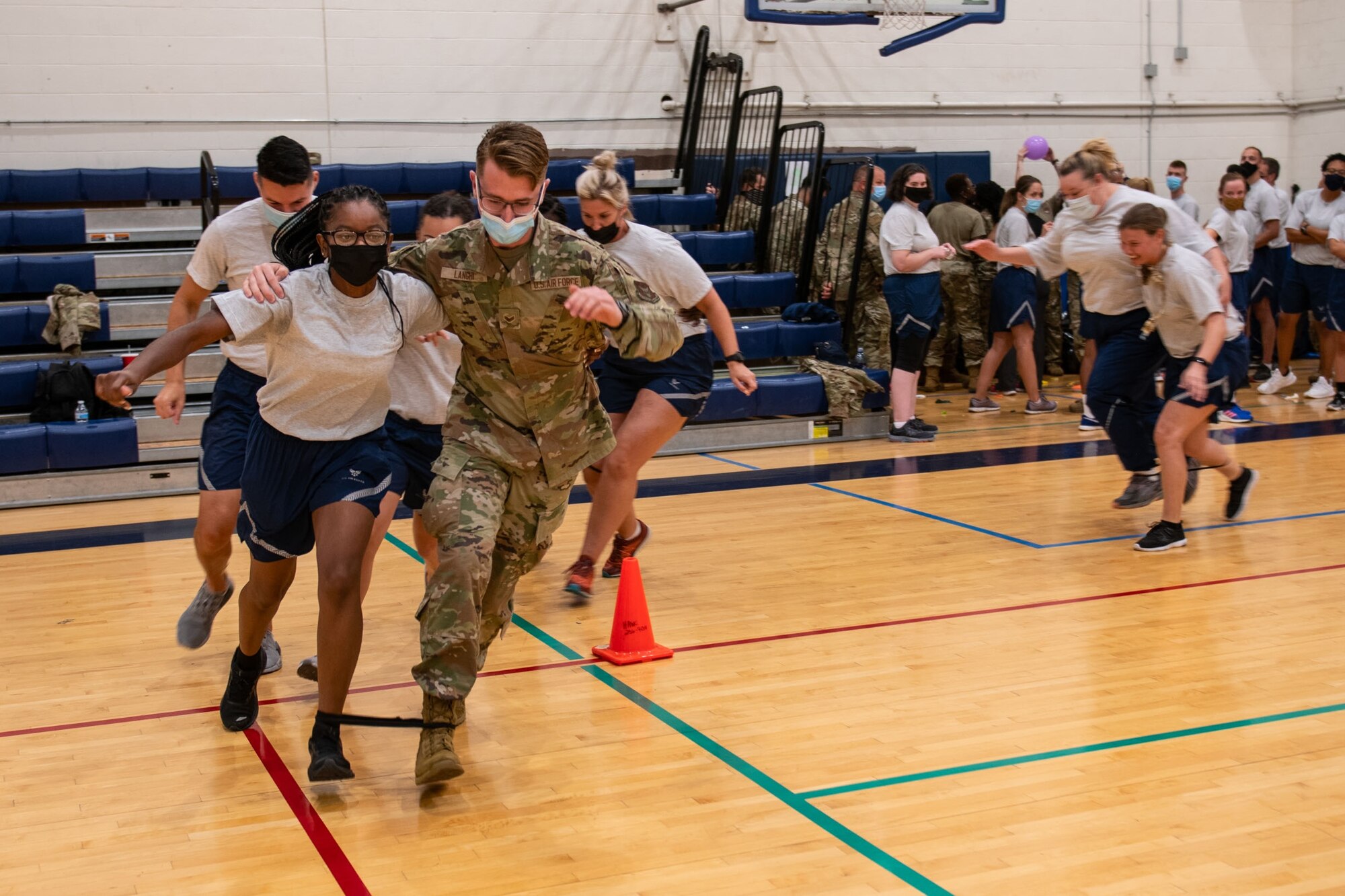 Members of the 932nd Medical Group participate in the three legged race activity during their annual sexual assault prevention and response/suicide prevention training, Scott Air Force Base, Illinois, Sept. 12, 2021. Each activity reviewed the training material, for example during the fit to fight activity a team of airman would be asked a training question and if answered correctly all other groups would do an exercise. (U.S. Air Force Photo by Staff Sgt. Brooke Spenner)
