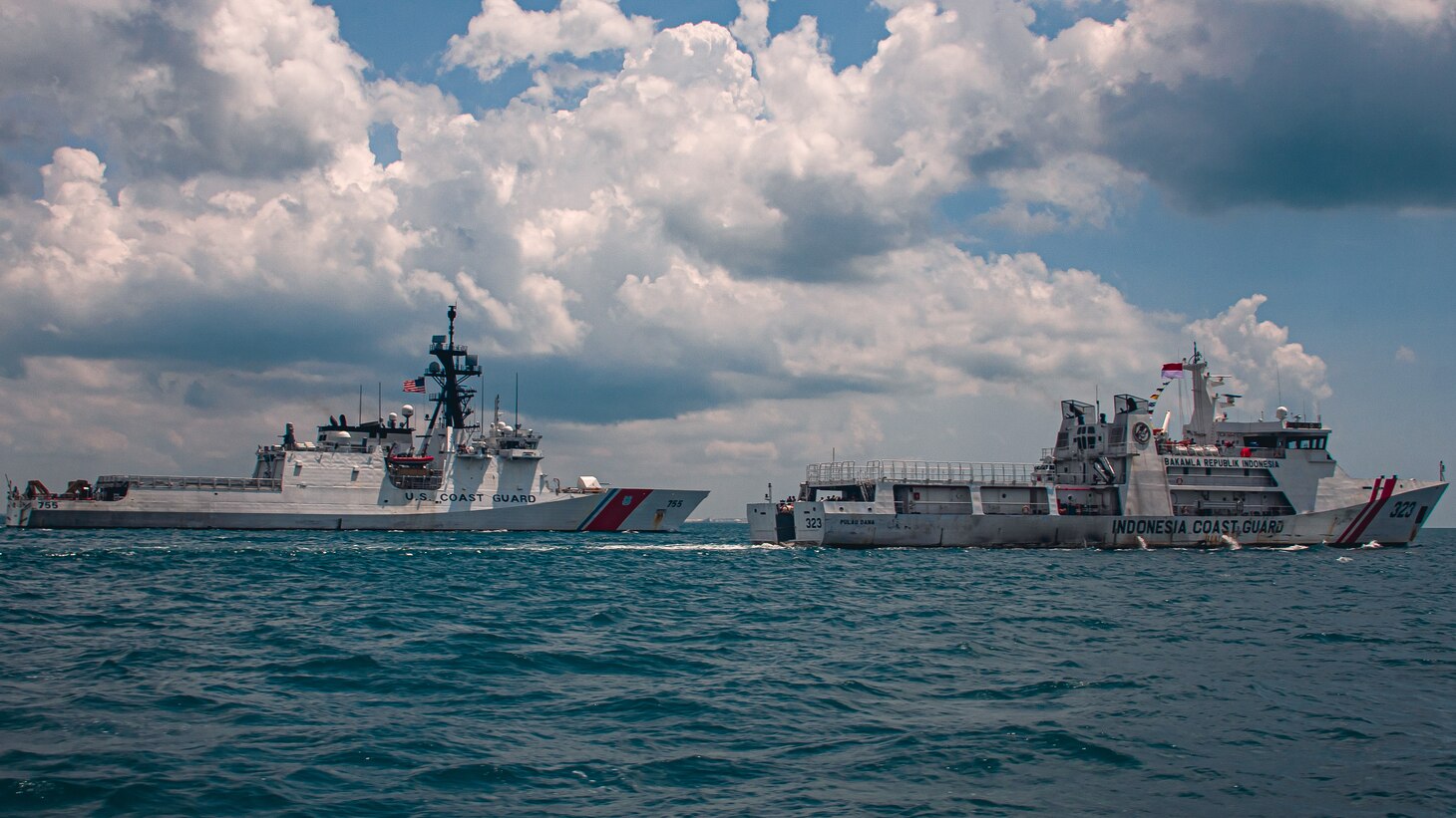 U.S. Coast Guard Cutter Munro steams in formation with Indonesia Coast Guard Vessel KN Pulau Dana during a maritime engagement with the Indonesia Coast Guard in the Singapore Straight, Sept. 20, 2021. Coast Guard Cutter Munro is currently deployed to the Western Pacific Ocean to strengthen alliances and partnerships, and improve maritime governance and security in the region. (U.S. Coast Guard photo by Marine Corps. Sgt. Kevin G Rivas)