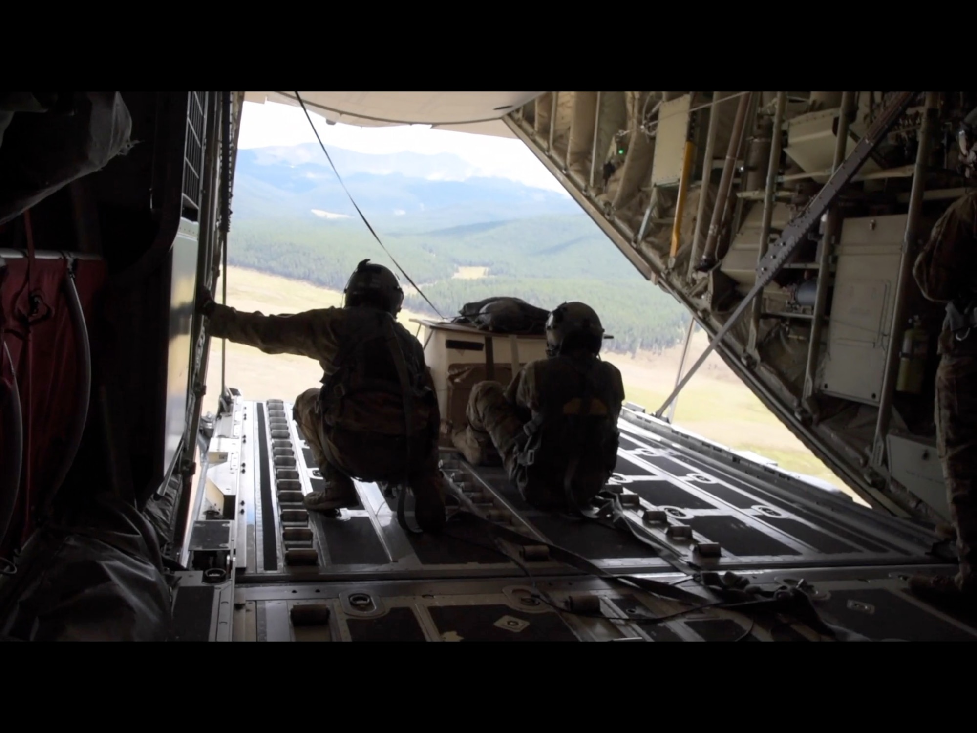 Tech. Sgt. Taylor Noel and Staff Sgt. Christopher Soto, 815th Airlift Squadron loadmasters, prepare to release a low-cost, low altitude bundle for the airdrop in Taylor Park, Colorado during the 22nd Air Force’s flagship exercise Rally in the Rockies Sept. 13-17, 2021. The exercise is designed to develop Airmen for combat operations by challenging them with realistic scenarios that support a full spectrum of operations during military actions, operations or hostile environments. (U.S. Air Force photo by Master Sgt. Jessica Kendziorek)