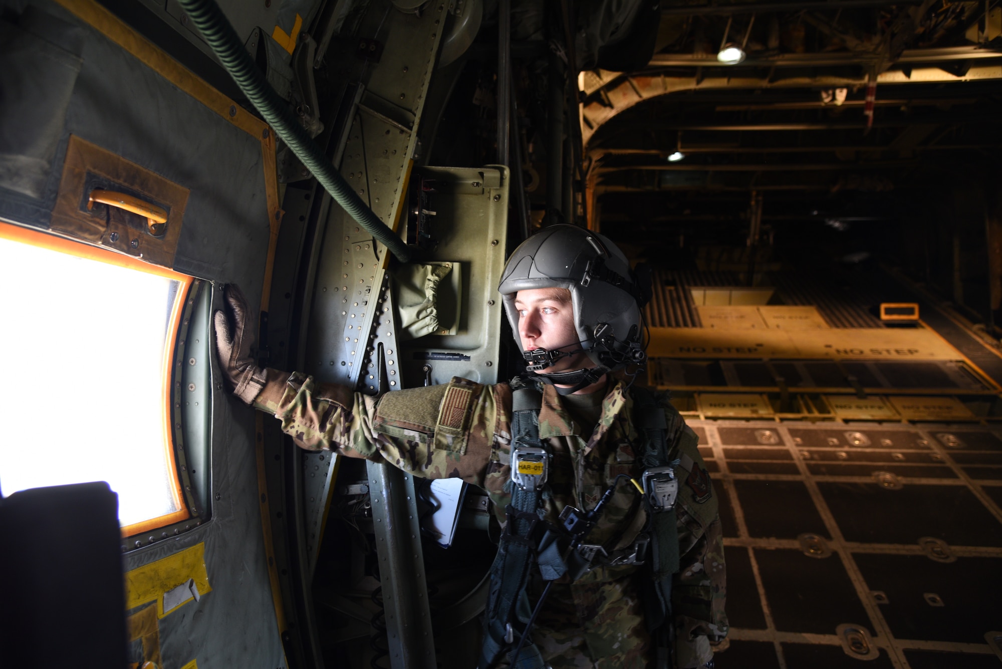 Senior Airman Kaleb Walker, 757th Airlift Squadron loadmaster, waits at the troop door until it is time to open the cargo ramp where the 10th Special Forces Group paratroopers will complete their jump during the 22nd Air Force’s flagship exercise Rally in the Rockies Sept. 13-17, 2021. The exercise is designed to develop Airmen for combat operations by challenging them with realistic scenarios that support a full spectrum of operations during military actions, operations or hostile environments. (U.S. Air Force photo by Master Sgt. Jessica Kendziorek)
