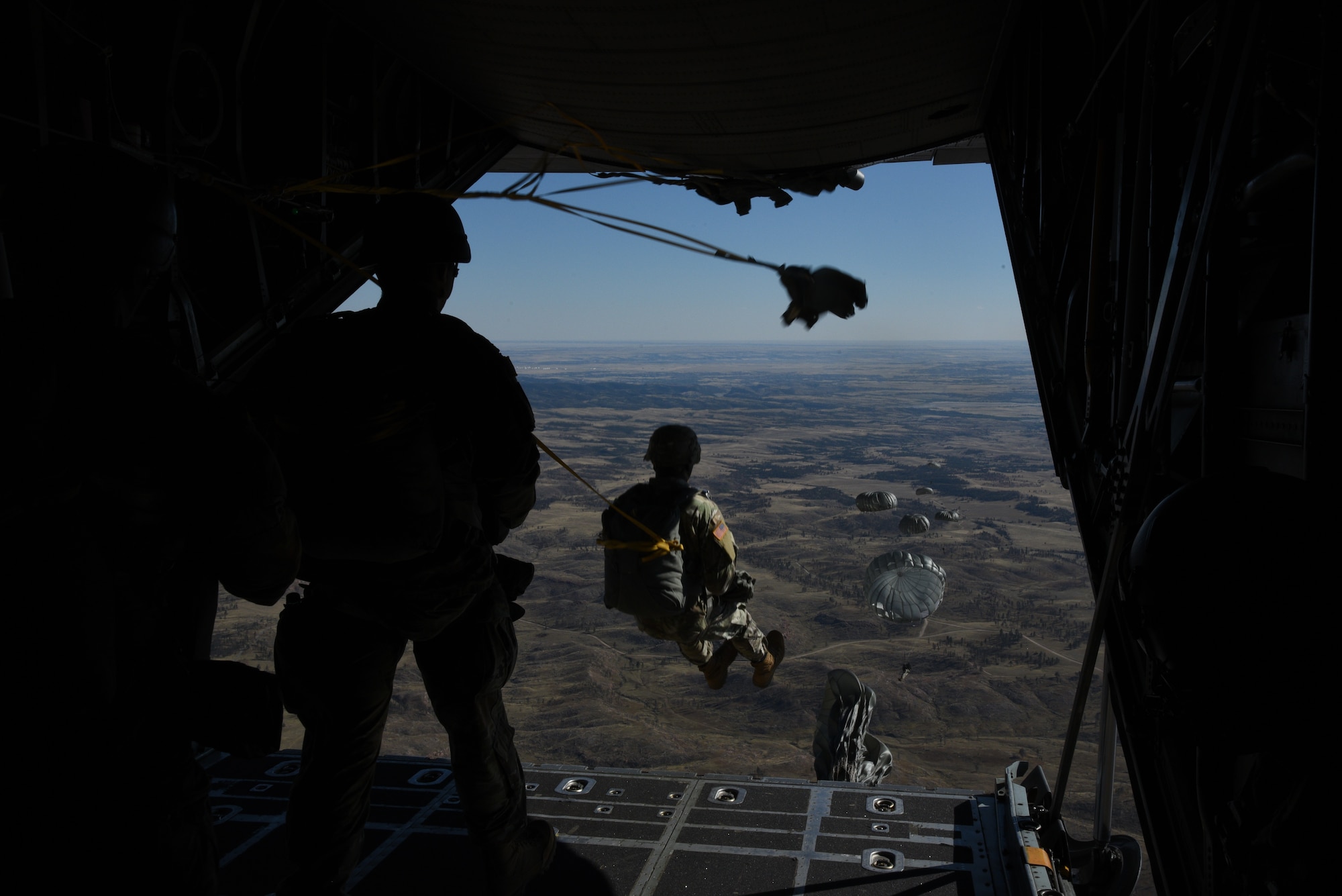 Paratroopers from the 10th Special Forces Group (Airborne) out of Fort Carson, Colorado complete their jump from the C-130H Hercules during the 22nd Air Force’s flagship exercise Rally in the Rockies Sept. 13-17, 2021. The exercise is designed to develop Airmen for combat operations by challenging them with realistic scenarios that support a full spectrum of operations during military actions, operations or hostile environments. (U.S. Air Force photo by Master Sgt. Jessica Kendziorek)