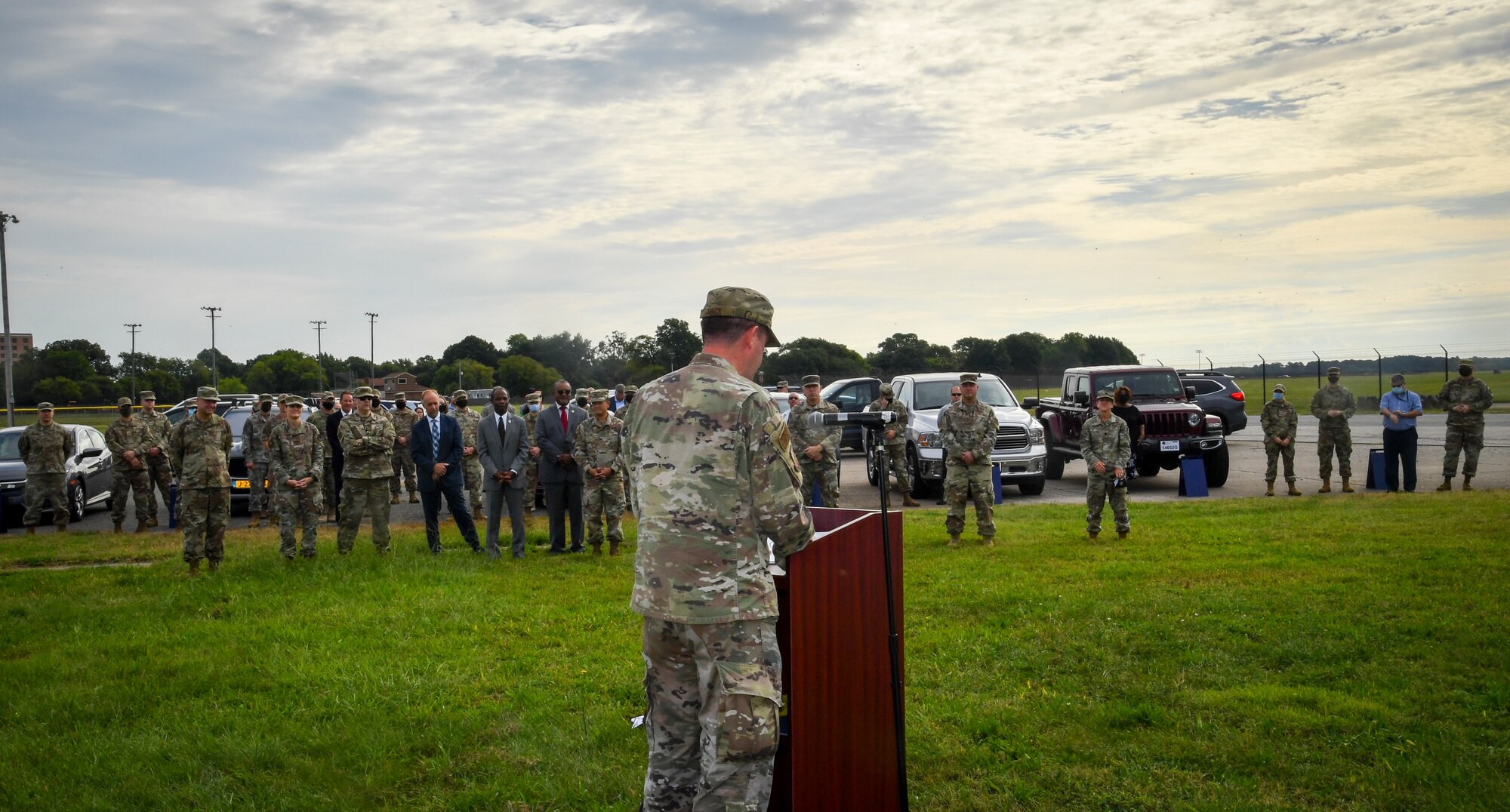 Individual speaks to a group of people behind a podium.