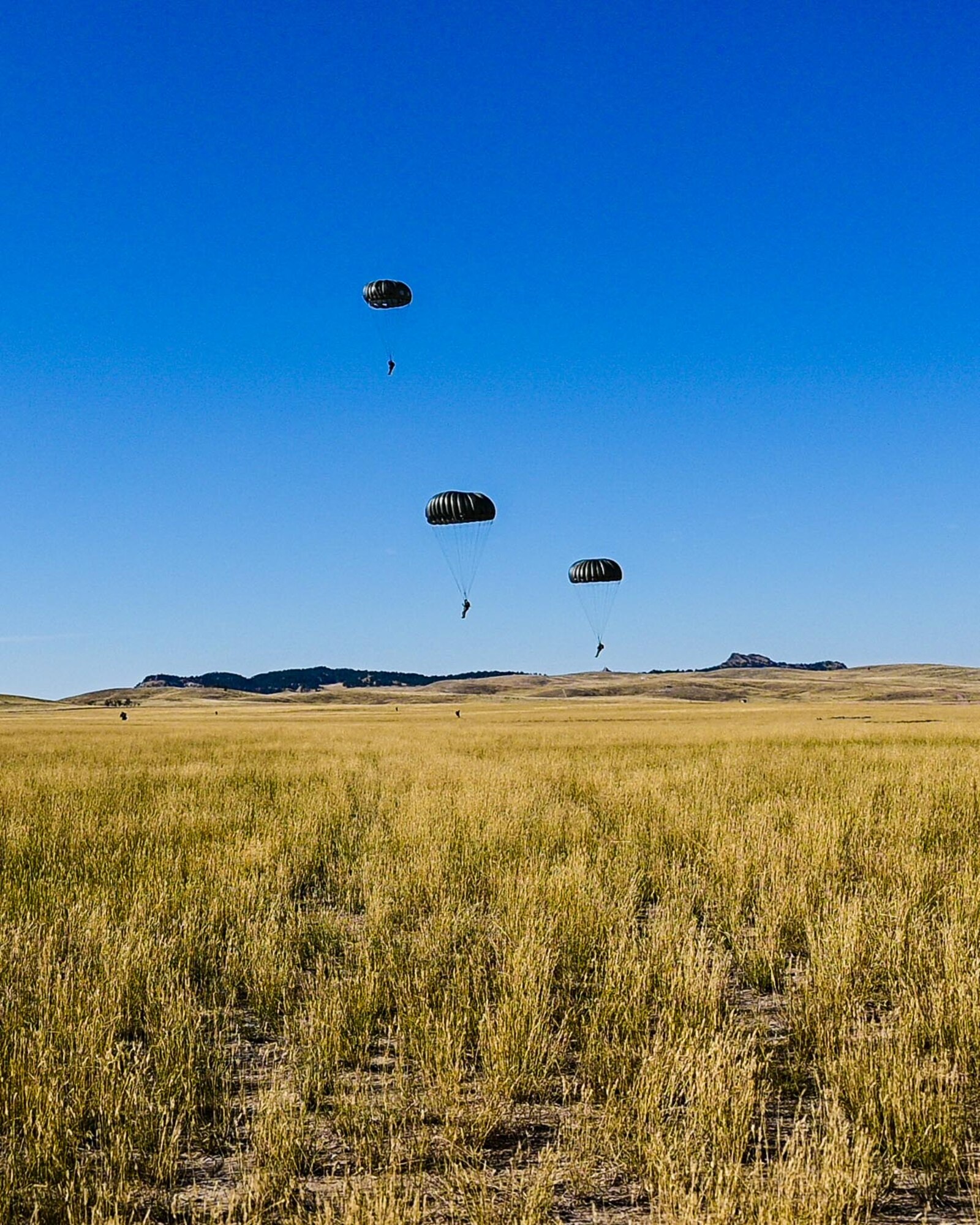 a cargo aircraft taking off from a dirt field