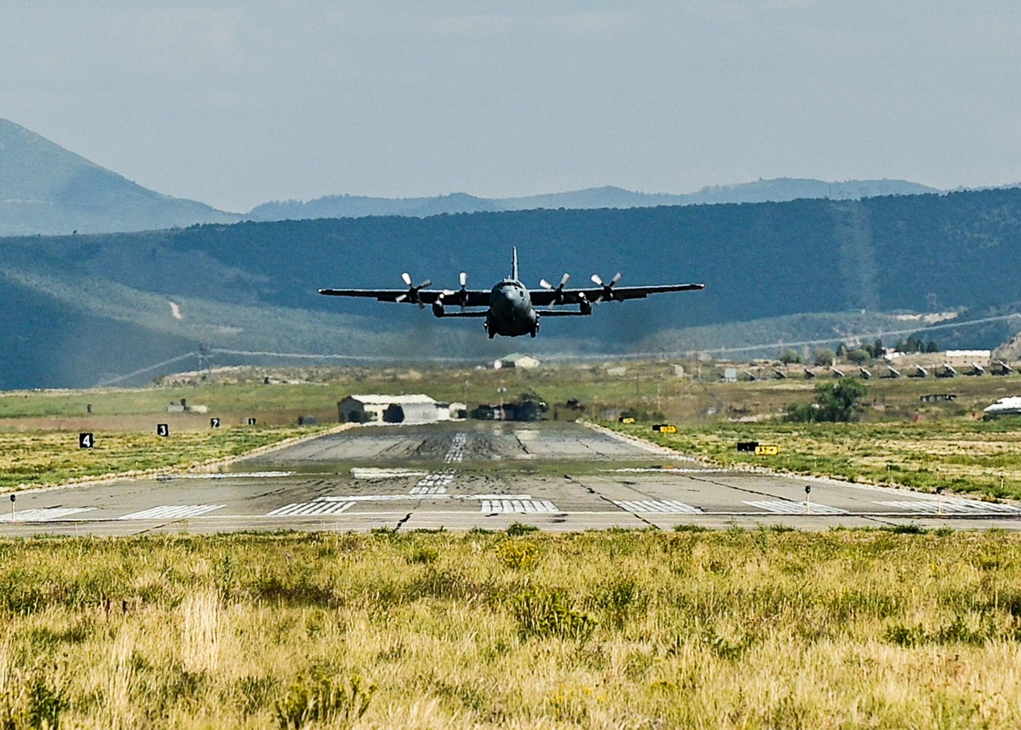 cargo aircraft in the sky above mountains