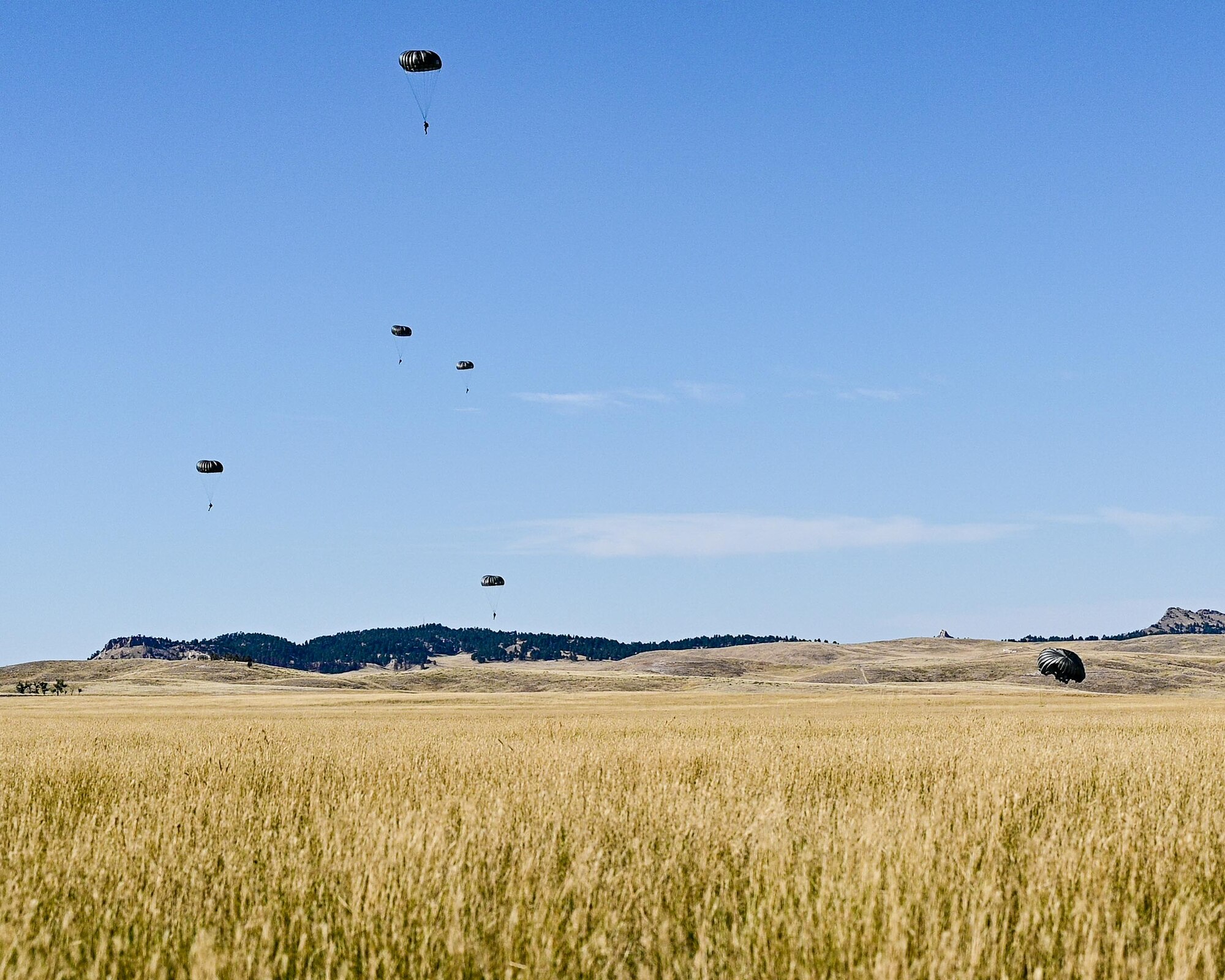 a cargo aircraft taking off from a dirt field